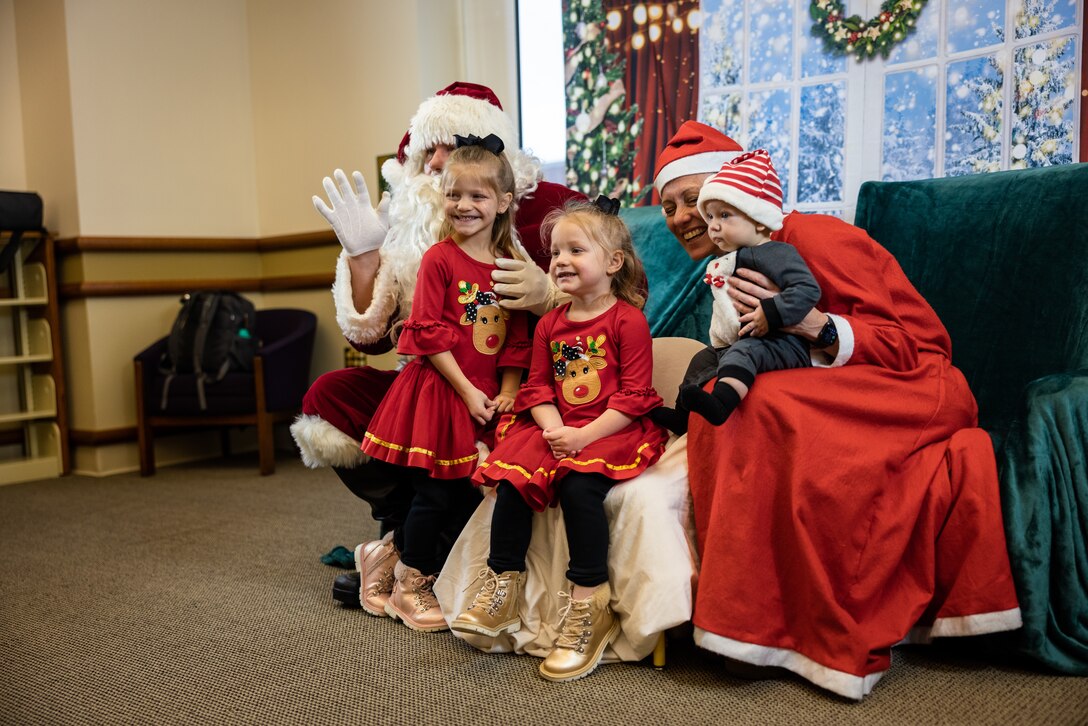 Children take a group photo with Santa Clause and Mrs. Clause during the Winter Bash at the Quantico Base Library on Marine Corps Base Quantico, Virginia, Dec. 15, 2022. Families and children of all ages were welcome to enjoy numerous activities, socialize with others and celebrate the holiday season. (U.S. Marine Corps photos by Lance Cpl. Joaquin Dela Torre)