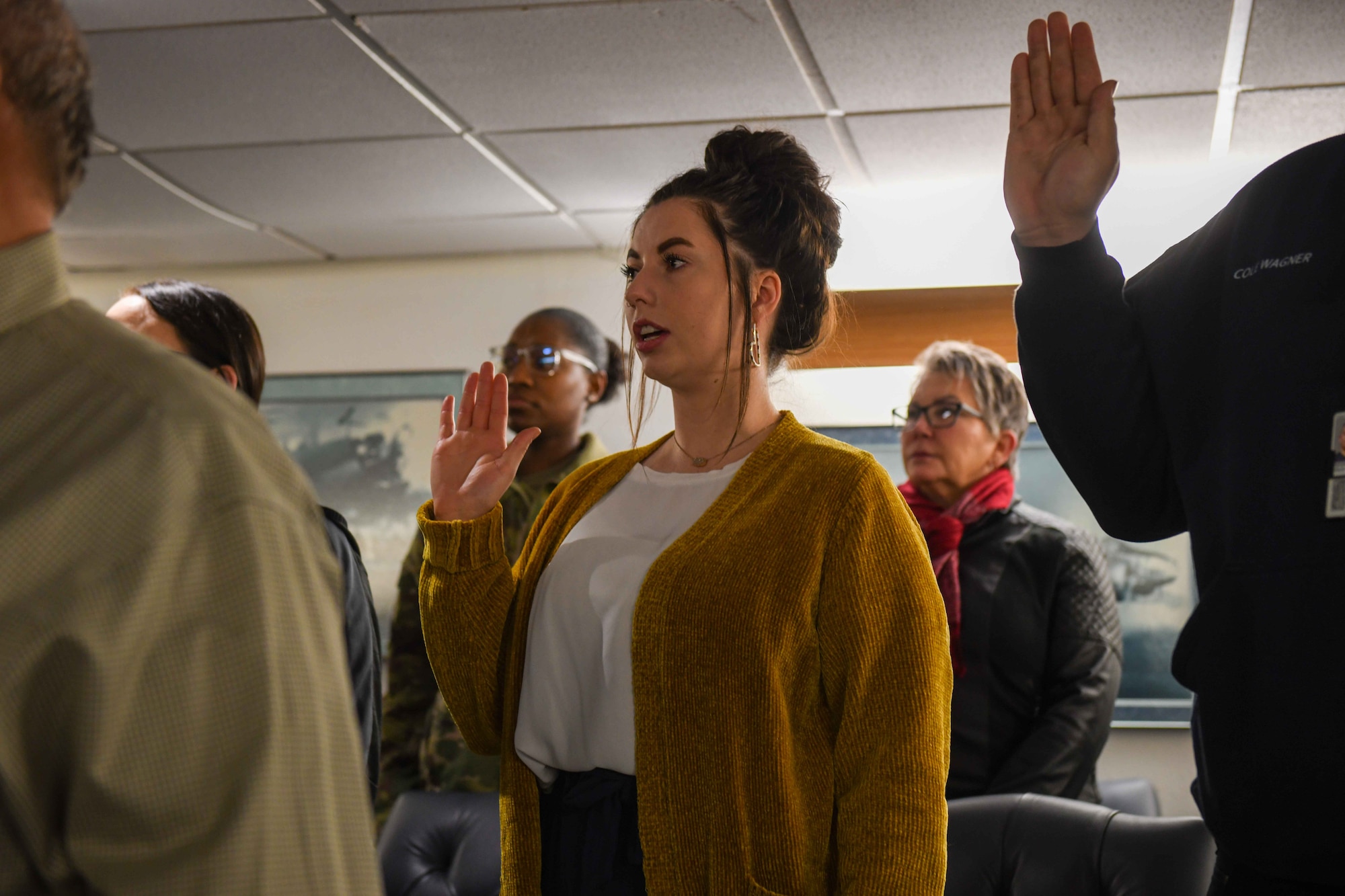 Mckynzi Forster, 97th Civil Engineer Squadron command section secretary, recites the oath for civilian airmen at Altus Air Force Base (AAFB), Oklahoma on Dec. 19, 2022. After they took the oath, the civilians were given orientation briefs from several different civilian employees on AAFB. (U.S. Air Force photo by Airman 1st Class Kari Degraffenreed)