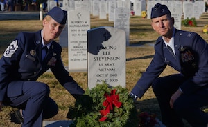 Col. Geoffrey Church, 9th Reconnaissance Wing commander, and Chief Master Sgt. Breana N. Oliver, 9th RW command chief, lay down a wreath  during the Wreaths Across America ceremony Dec. 17, 2022, at Sutter Cemetery, Sutter, Calif.