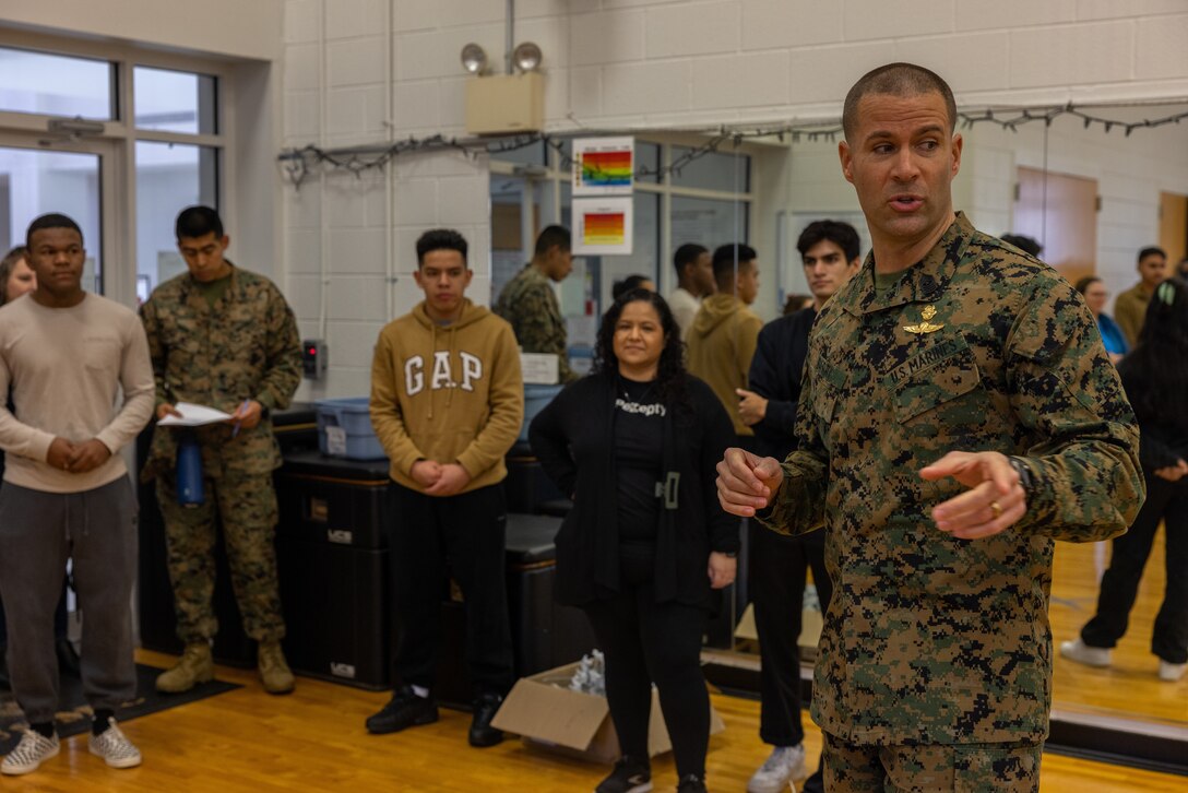 U.S. Marine Corps Sgt. Maj. Collin D. Barry, sergeant major, Marine Corps Base Quantico, talks to a group of participants at the Holiday in the Barracks bag stuffing event hosted by the Marine Corps Base Quantico Single Marine Program at the Semper Fit Barber Gym on Marine Corps Base Quantico, Virginia, Dec. 16, 2022. During the Holiday in the Barracks bag stuffing, Quantico's Single Marine Program and additional volunteers, stuffed 300 gift bags for active duty single Marines in preparation for the Holiday in the Barracks event.  (U.S. Marine Corps photo by Lance Cpl. Jeffery Stevens)