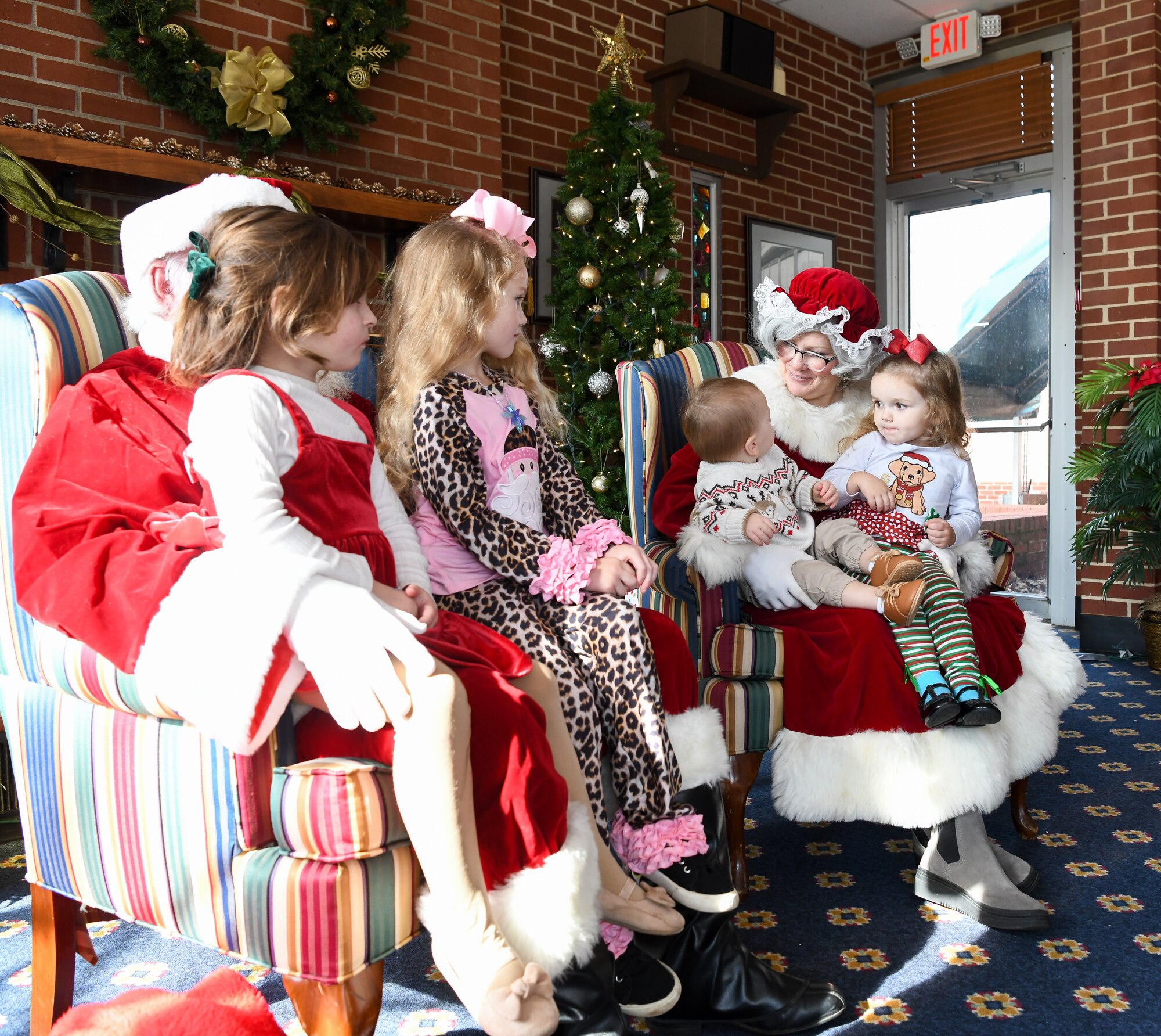 Children sitting on the laps for Santa and Mrs. Claus