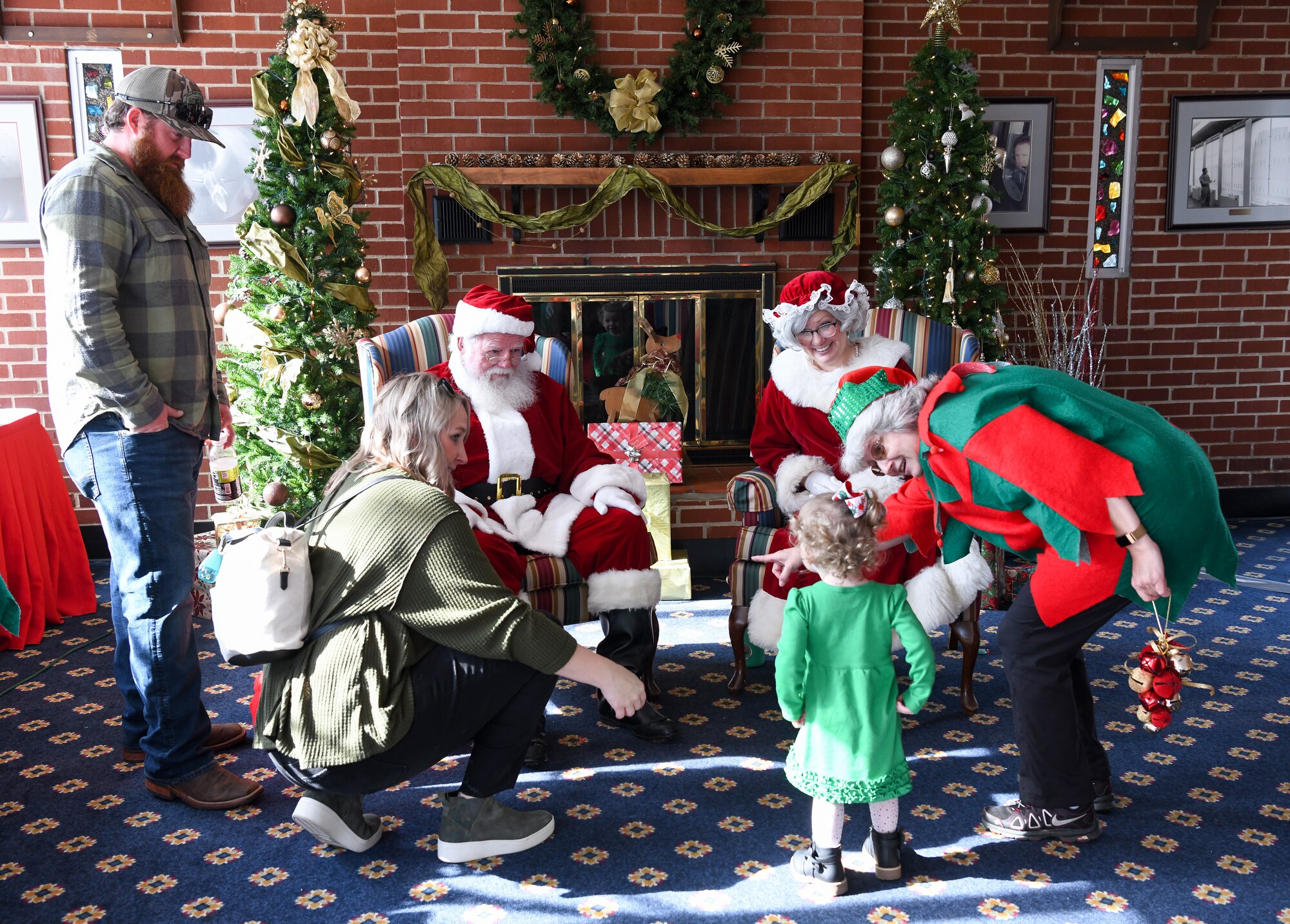Child and adults with Santa and Mrs. Claus