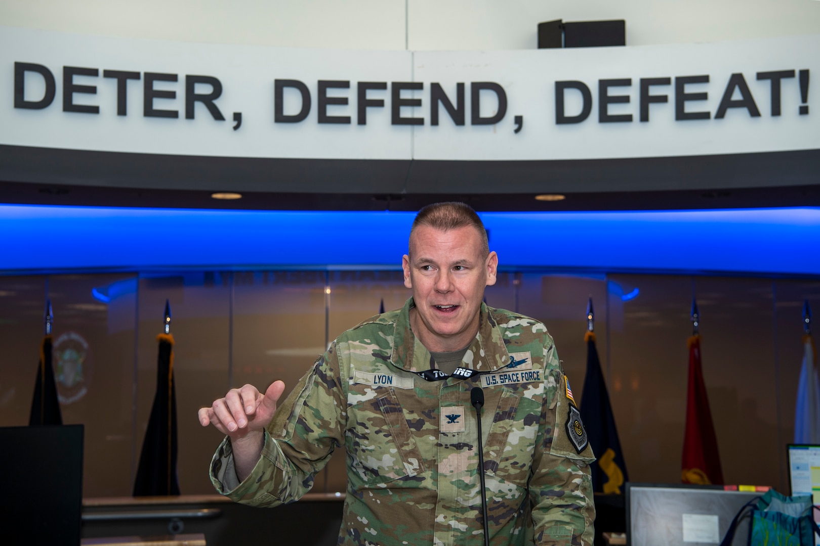 Man in military uniform talking into microphone