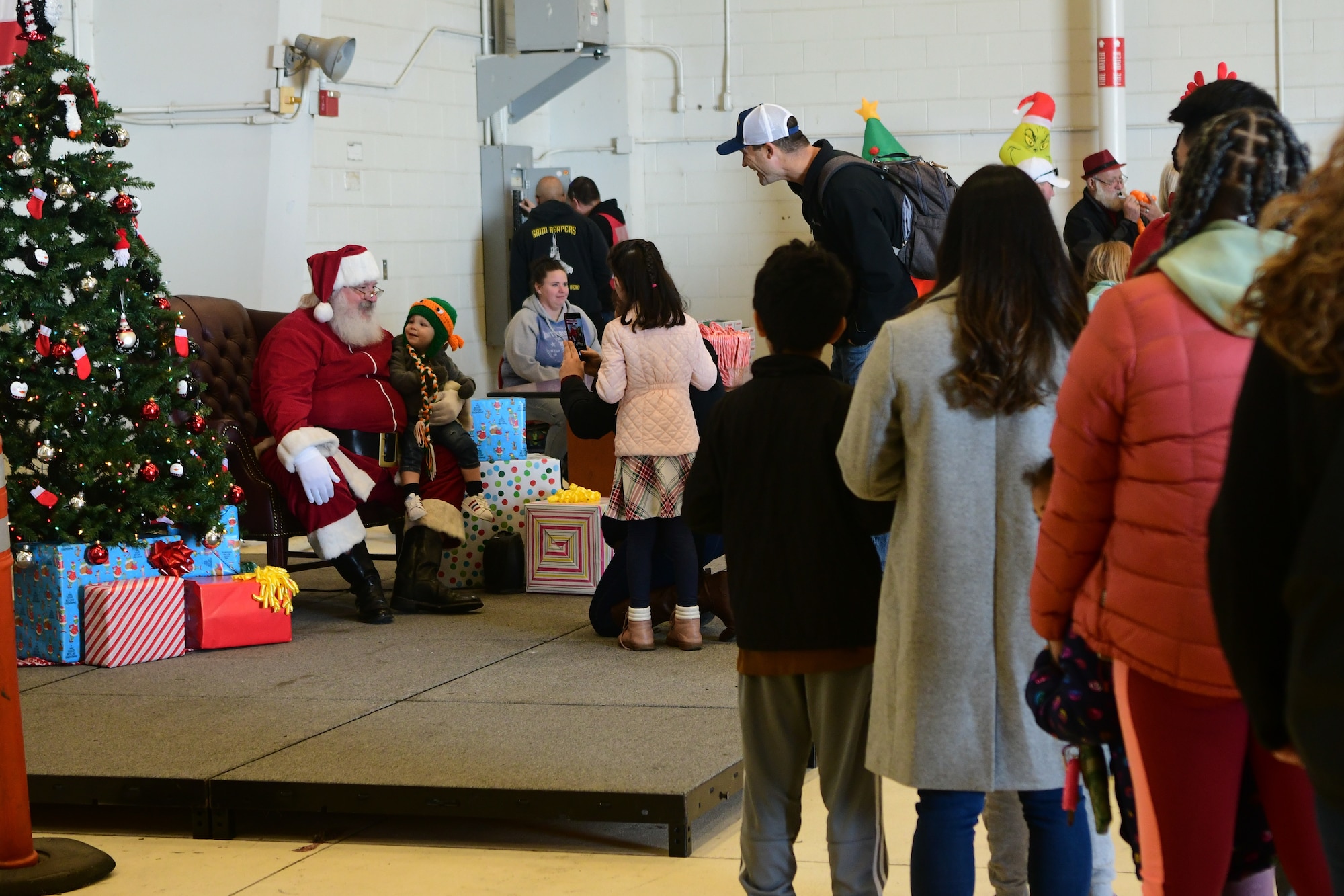 Winterfest participants wait in line to get a photo with Santa on the flightline at Beale Air Force Base, Calif., on Dec. 17, 2022.