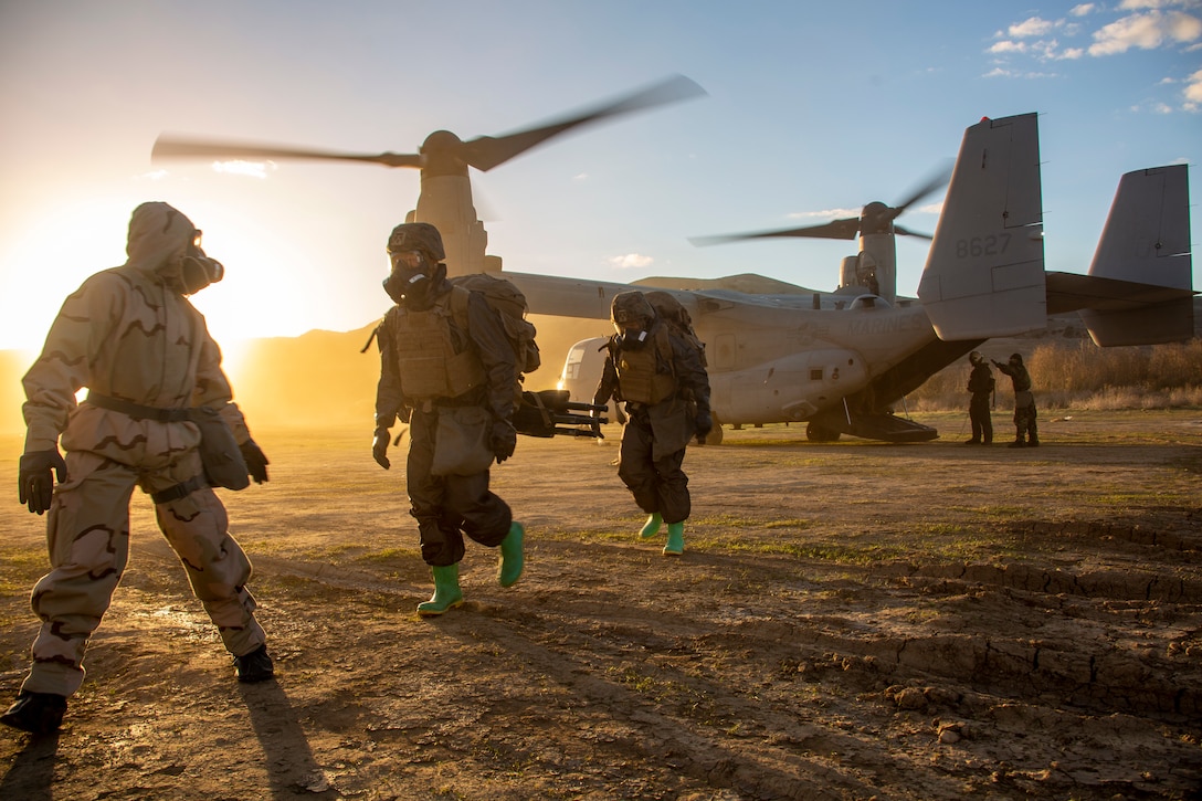 U.S. Marines with 1st Marine Division G-3 Chemical, Biological, Radiological and Nuclear Defense platoon, I Marine Expeditionary Force, are led to a thorough decontamination station during exercise Steel Knight 23, on Marine Corps Base Camp Pendleton, California, Dec. 7, 2022. 3rd Marine Aircraft Wing and 1st Marine Division Marines executed a tactical site exploitation into a potentially contaminated environment. Exercise Steel Knight 23 provides 1st Marine Division and 3rd MAW an opportunity to refine Division and Wing-level warfighting in support of I MEF and fleet maneuver.