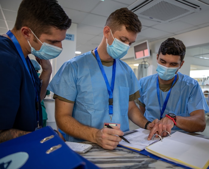 medical service members reading patient chart