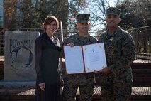 U.S. Marine Corps Lt. Gen. Brian W. Cavanaugh, the commanding general for Fleet Marine Force, Atlantic (FMFLANT), Marine Forces Command (MARFORCOM), Marine Forces Northern Command (MARFOR NORTHCOM), Brig. Gen. John F. Kelliher III, the deputy commanding general for FMFLANT, MARFORCOM, MARFOR NORTHCOM, and his wife Mrs. Susan Kelliher hold award given during a promotion ceremony at Naval Support Activity Hampton Roads, Virginia, Dec. 16, 2022. During his 30 years of service he accumulated more than 4,500 mishap-free flight hours in seven different aircrafts. General officers are nominated for promotion by the President and confirmed by the Senate. As a newly promoted Maj. Gen., Kelliher’s responsibilities include overseeing the staff's planning and coordination of missions. (U.S. Marine Corps photo by Lance Cpl. Jack Chen)