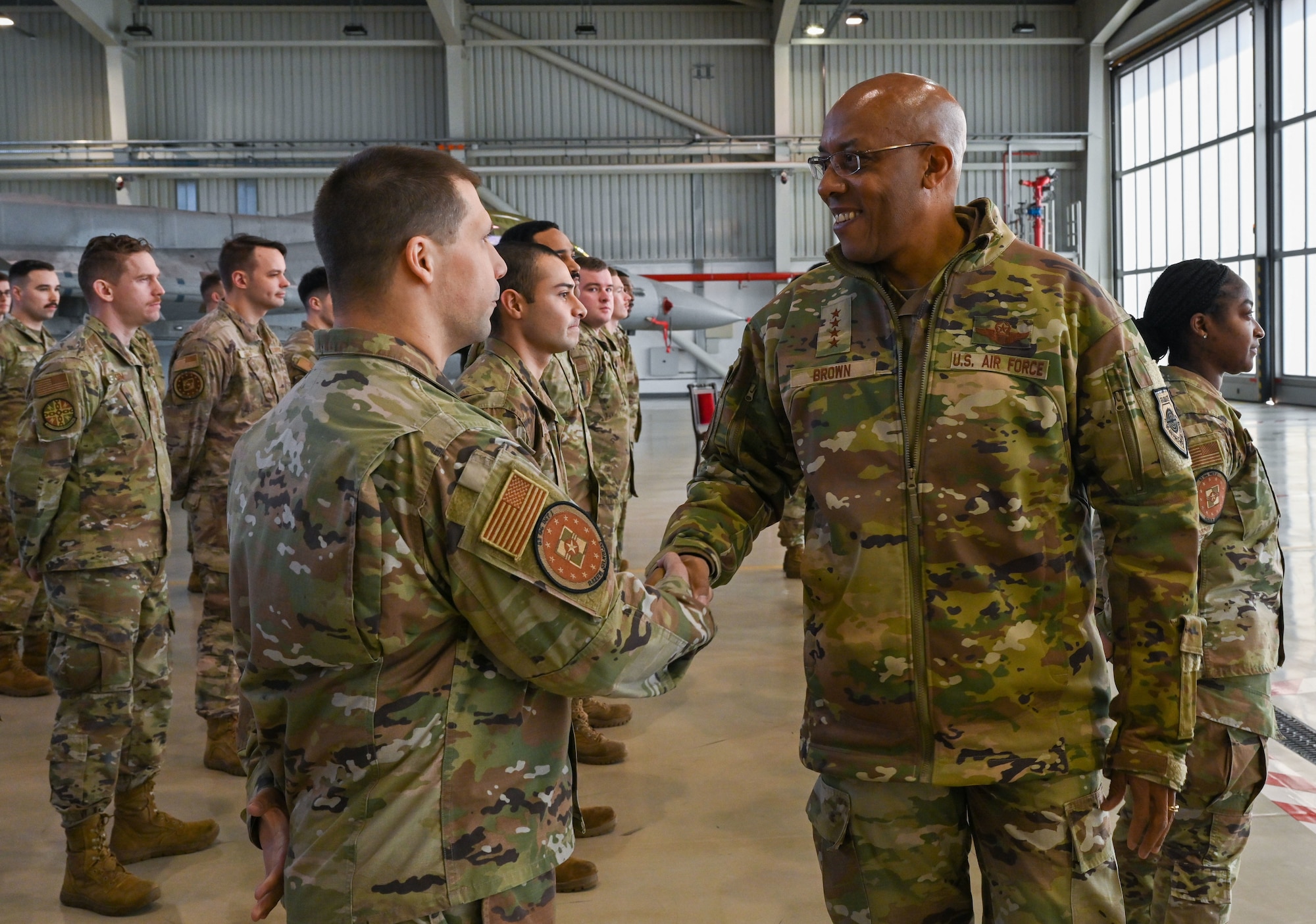 Two military members shake hands