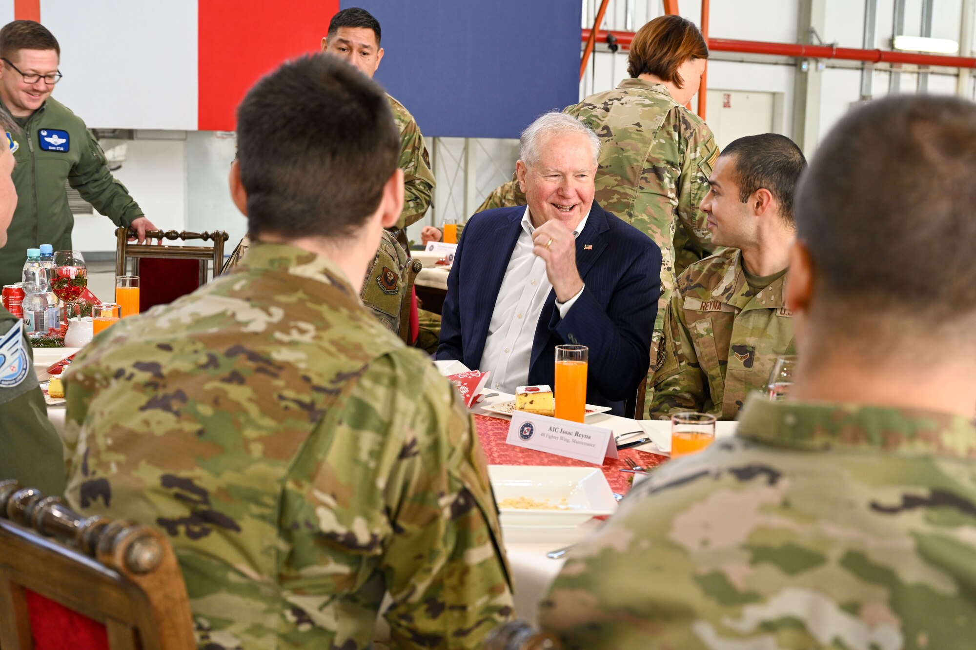 Military members interact sitting at a table