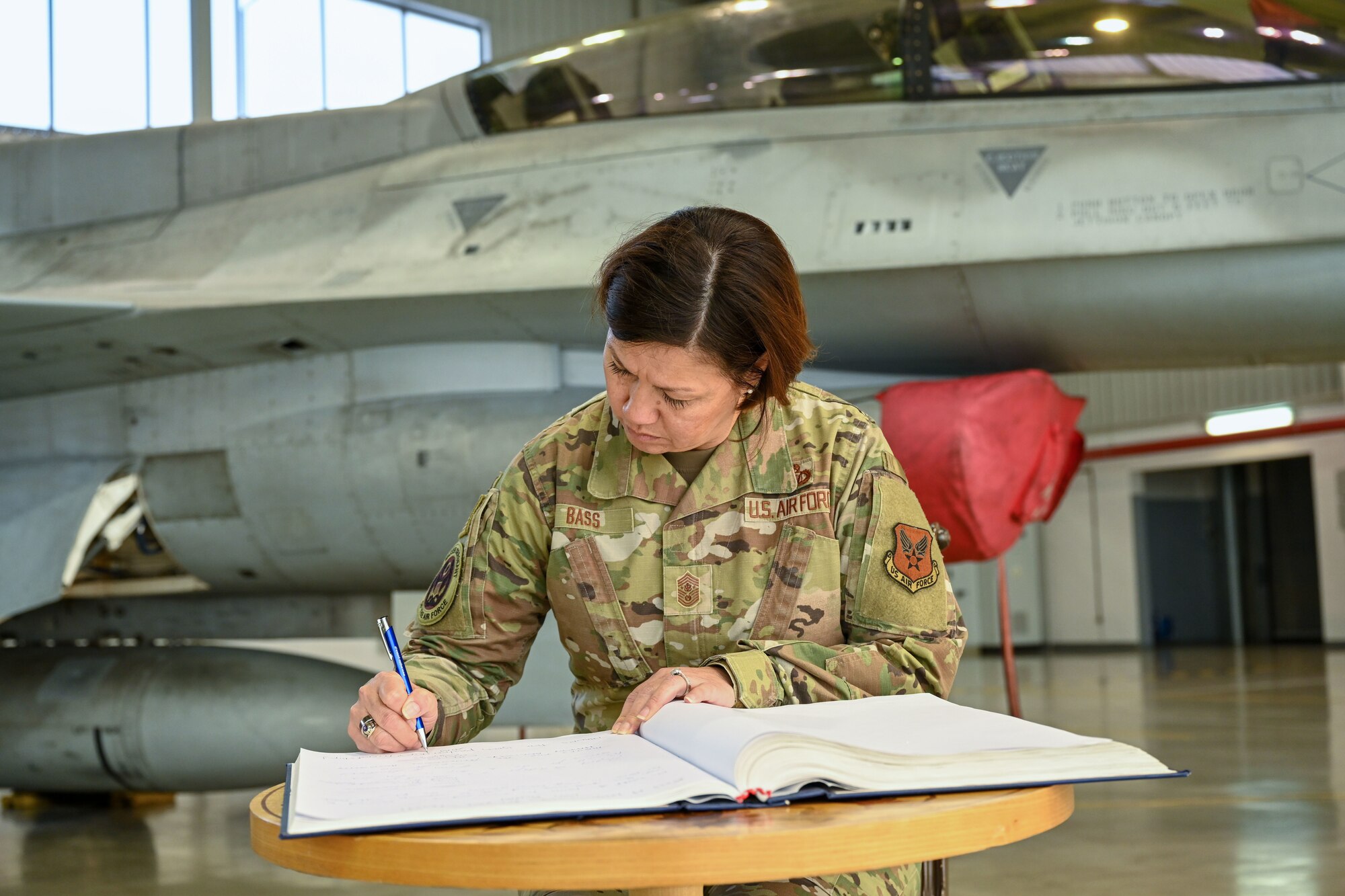 Military woman signs a book