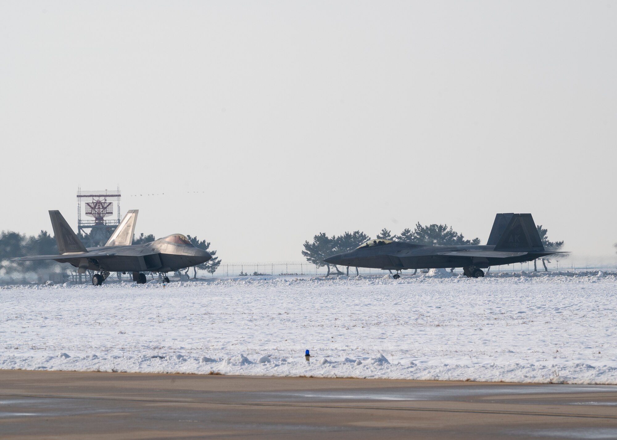 Two F-22 Raptors assigned to the 525th Fighter Squadron out of Joint-Base Elmendorf-Richardson, Alaska, arrive at Kunsan Air Base, Republic of Korea, Dec. 20, 2022.