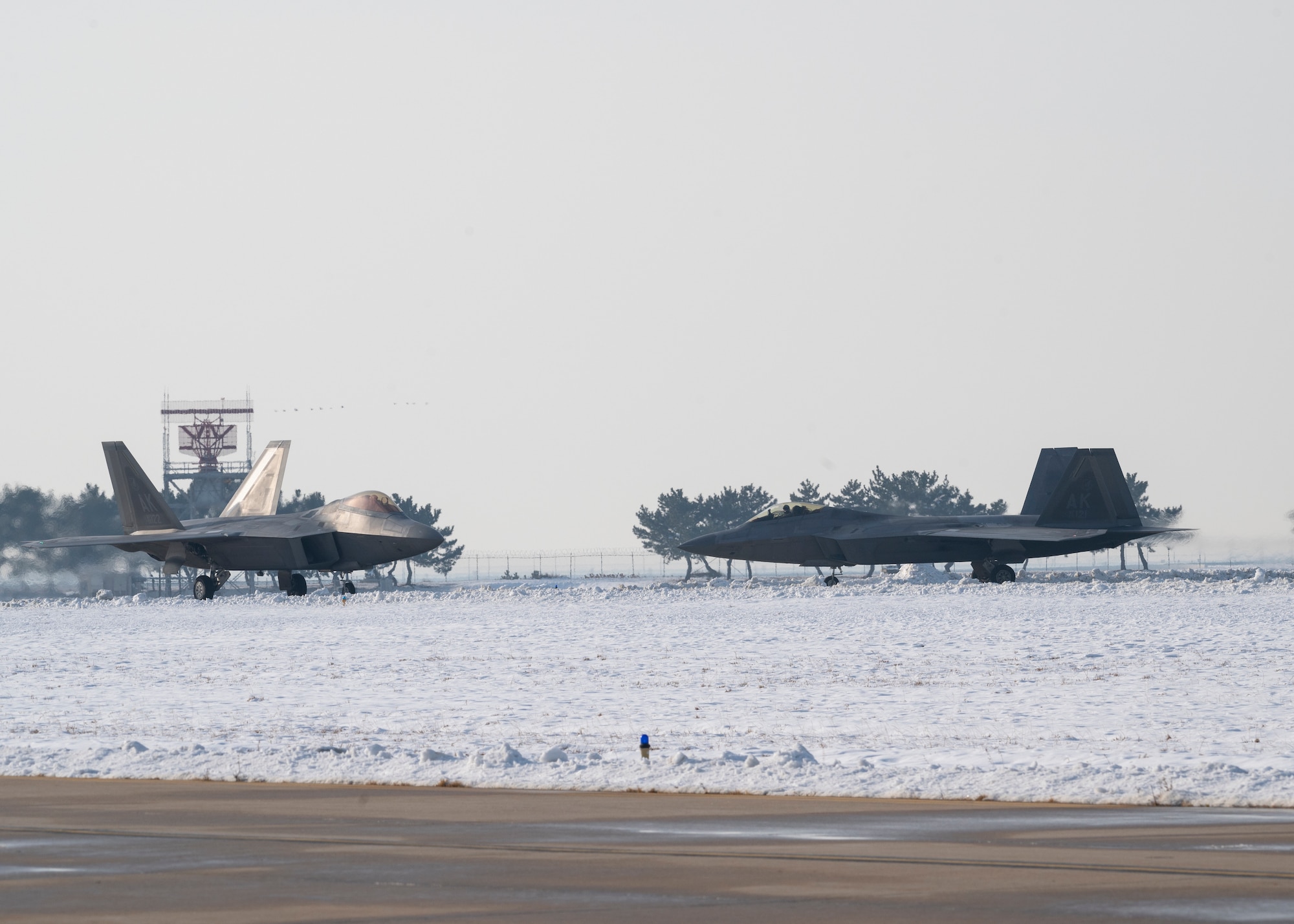 Two F-22 Raptors assigned to the 525th Fighter Squadron out of Joint-Base Elmendorf-Richardson, Alaska, arrive at Kunsan Air Base, Republic of Korea, Dec. 20, 2022.