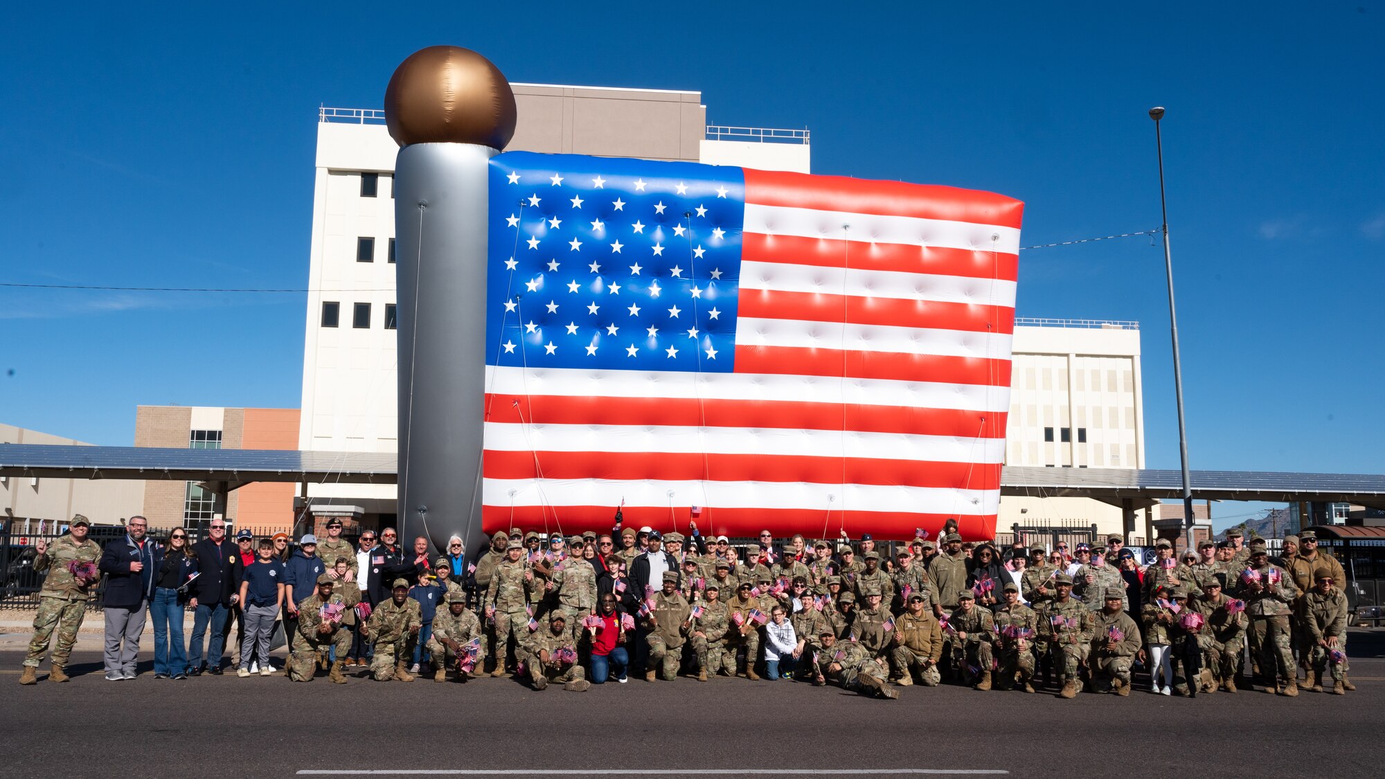 U.S. Air Force Airmen and members of the Fighter Country Foundation pose for a group photo during the Fiesta Bowl Parade, Dec. 17, 2022, in Phoenix, Arizona.