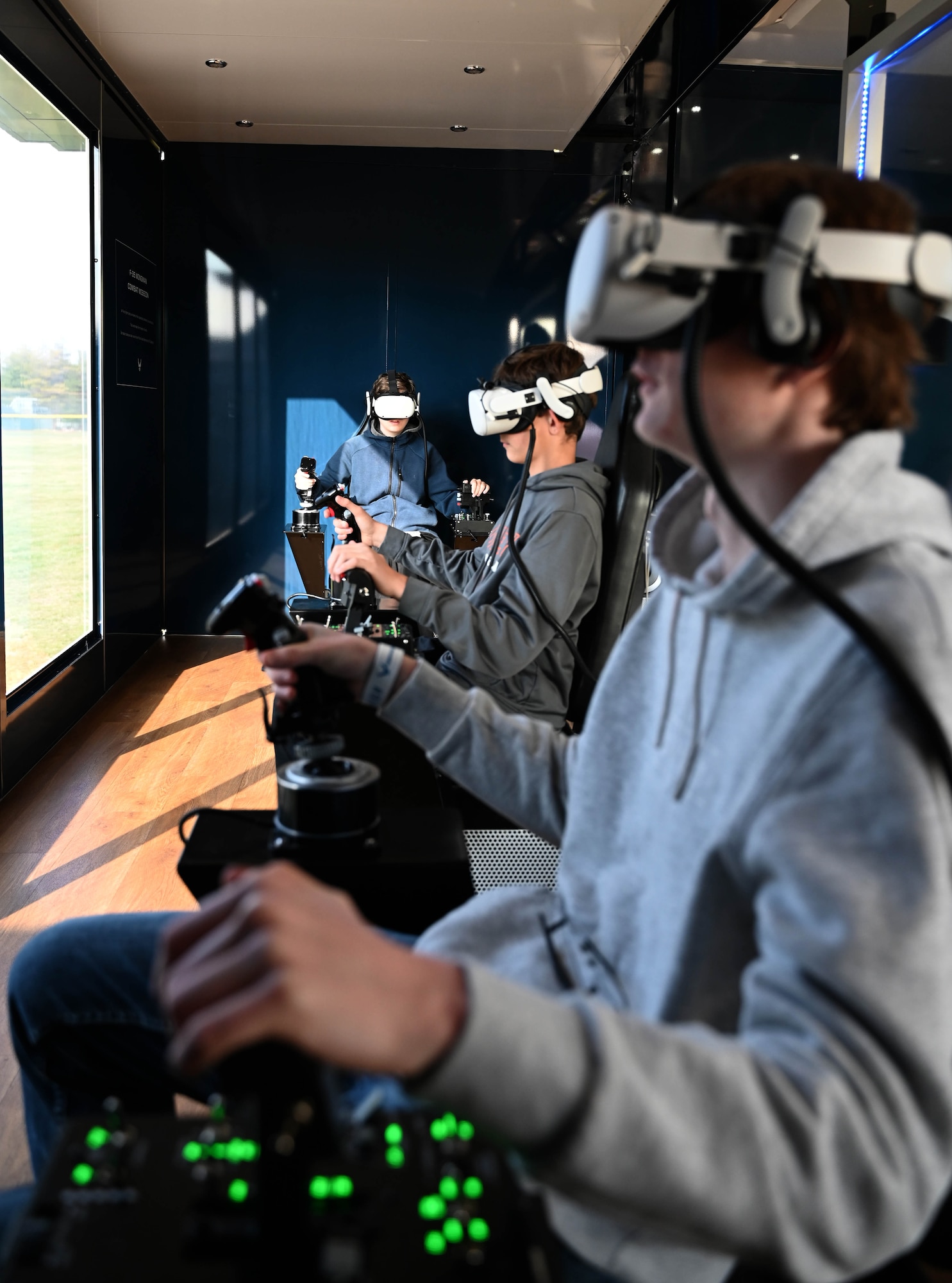 High school students operate an Air Force F-35 computer flight simulation