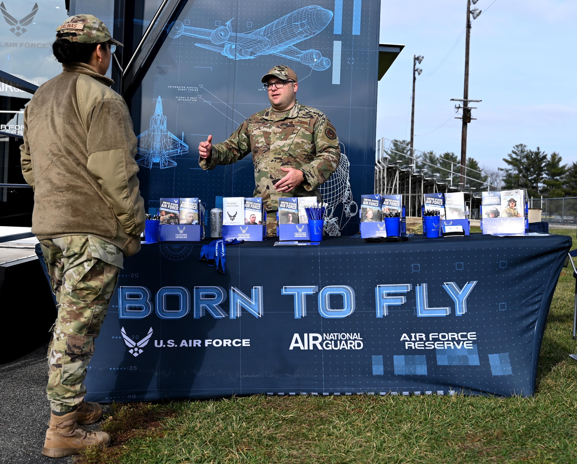 Air Force recruiters talk at a recruiting booth