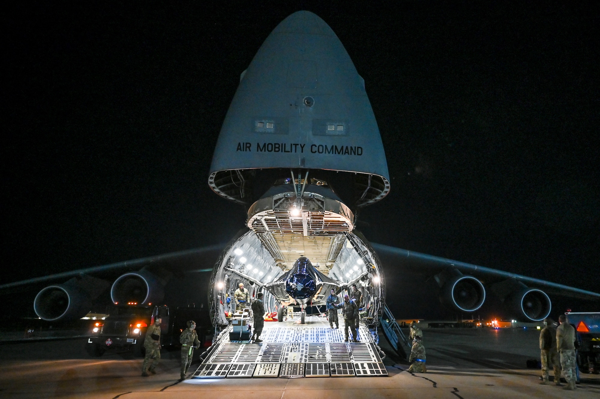 The fuselage of an F-22 Raptor is about to emerge from inside a C-5M Galaxy