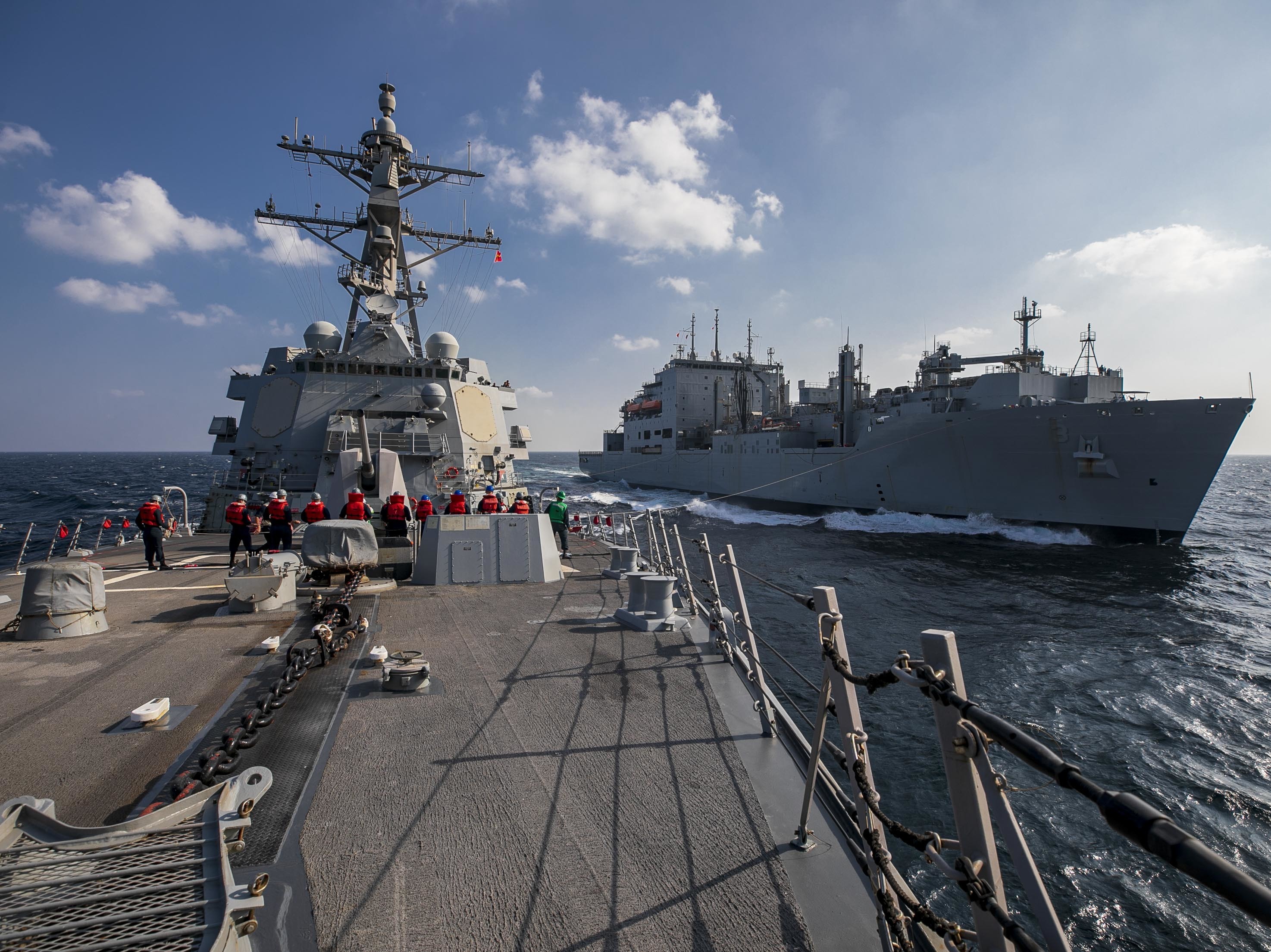 The guided-missile destroyer USS Delbert D. Black (DDG 119) and the Military Sealift Command dry cargo and ammunition ship USNS Alan Shepard (T-AKE 3) conduct a replenishment-at-sea in the Arabian Gulf.