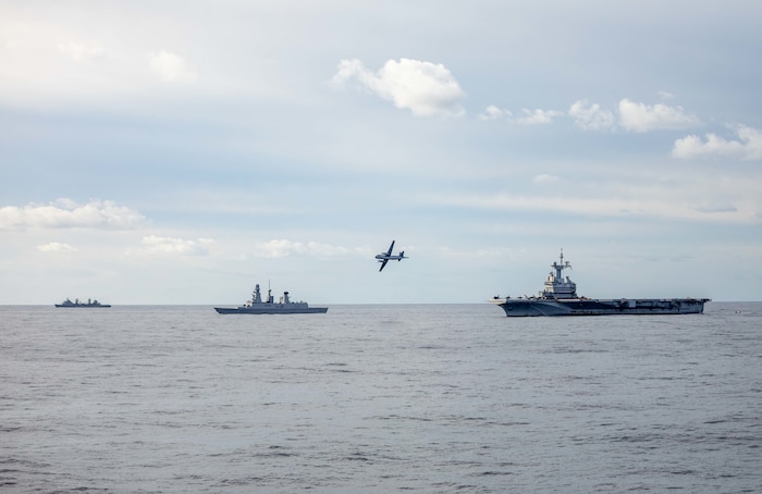 A French Dassault Atlantique 2 flies by the French aircraft carrier FS Charles de Gaulle (R 91), right, and the French frigate FS Forbin (D620), middle, and the French replenishment oiler FS Marne (A630), left, after dropping off a group of French paratroopers, Nov. 26, 2022. The Arleigh Burke-class guided-missile destroyer USS Roosevelt (DDG 80), currently attached to the Charles de Gaulle Carrier Strike Group, is on a scheduled deployment in the U.S. Naval Forces Europe area of operations, employed by U.S. Sixth Fleet to defend U.S., allied and partner interests.