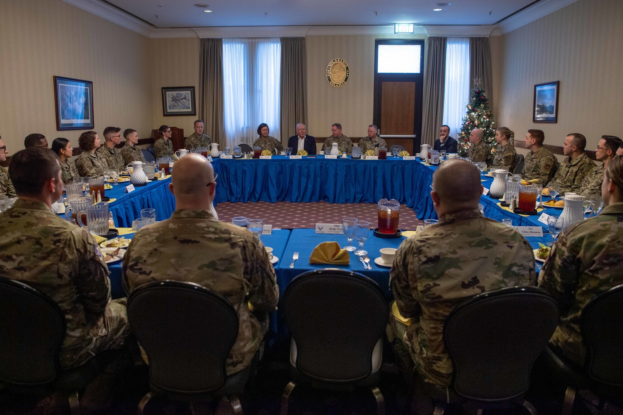 Secretary of the Air Force Frank Kendall sits with Airmen for lunch after a base tour