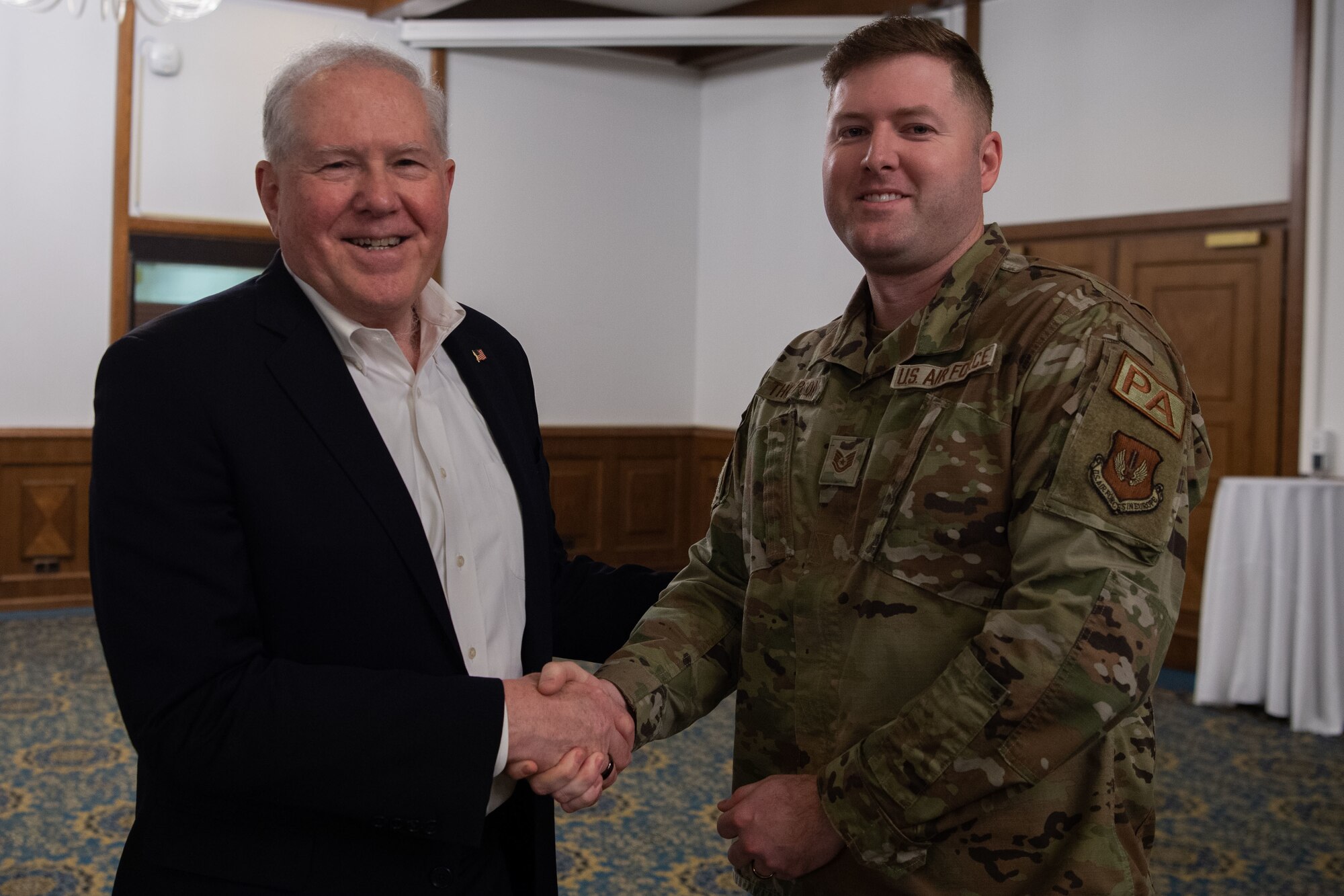 Secretary of the Air Force Frank Kendall coins Tech. Sgt. Peter Thompson, 86th Airlift Wing Public Affairs mission partner support noncommissioned officer in charge