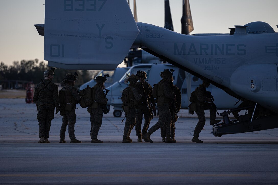 U.S. Marines with Battalion Landing Team 1/6 (BLT), 26th Marine Expeditionary Unit (MEU), board a MV-22 Osprey assigned to Medium Tiltrotor Squadron 162 (Reinforced) during Marine Expeditionary Unit Exercise (MEUEX) I, at Marine Corps Auxiliary Landing Field Bogue, North Carolina, Dec. 19, 2022. BLT 1/6 conducted a tactical recovery of aircraft and personnel, one of multiple scenario-based exercises conducted during MEUEX I, a 15-day field exercise executing various types of missions tasked for the newly composited Marine Air-Ground Task Force. (U.S. Marine Corps photo by Cpl. Michele Clarke)