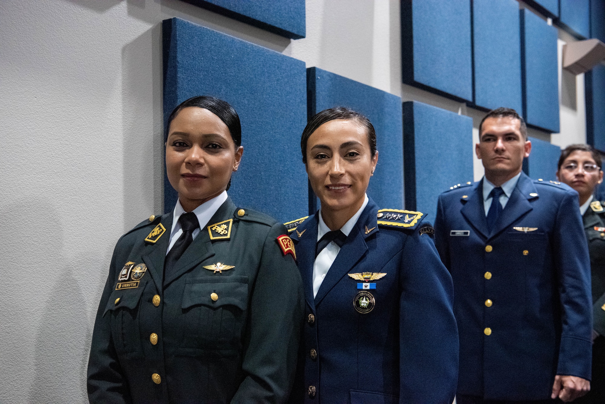 International military students smile before approaching the stage during the Inter-American Air Forces Academy’s graduation ceremony at Joint Base San Antonio-Lackland, Texas, Dec. 7, 2022. More than 150 international military students from 12 partner nations across Latin America and the USAF graduated during the last training cycle of 2022. (U.S. Air Force photo by Vanessa R. Adame)