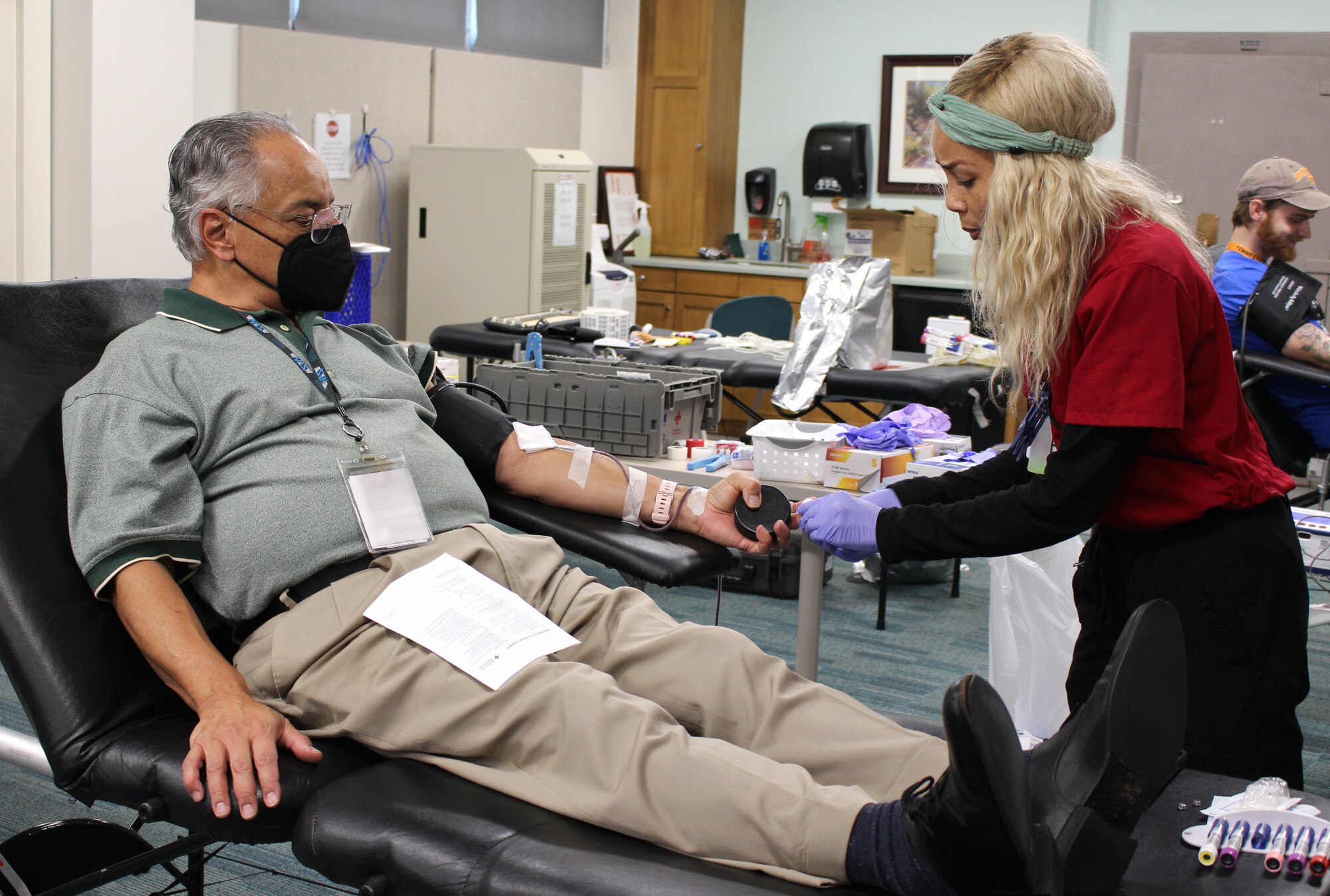 Gus Martinez, left, an Arnold Engineering Development Complex team member gives blood during an American Red Cross Blood Drive Dec. 8, 2022, at Arnold Air Force Base, Tennessee. Also pictured to the right is a nurse.
