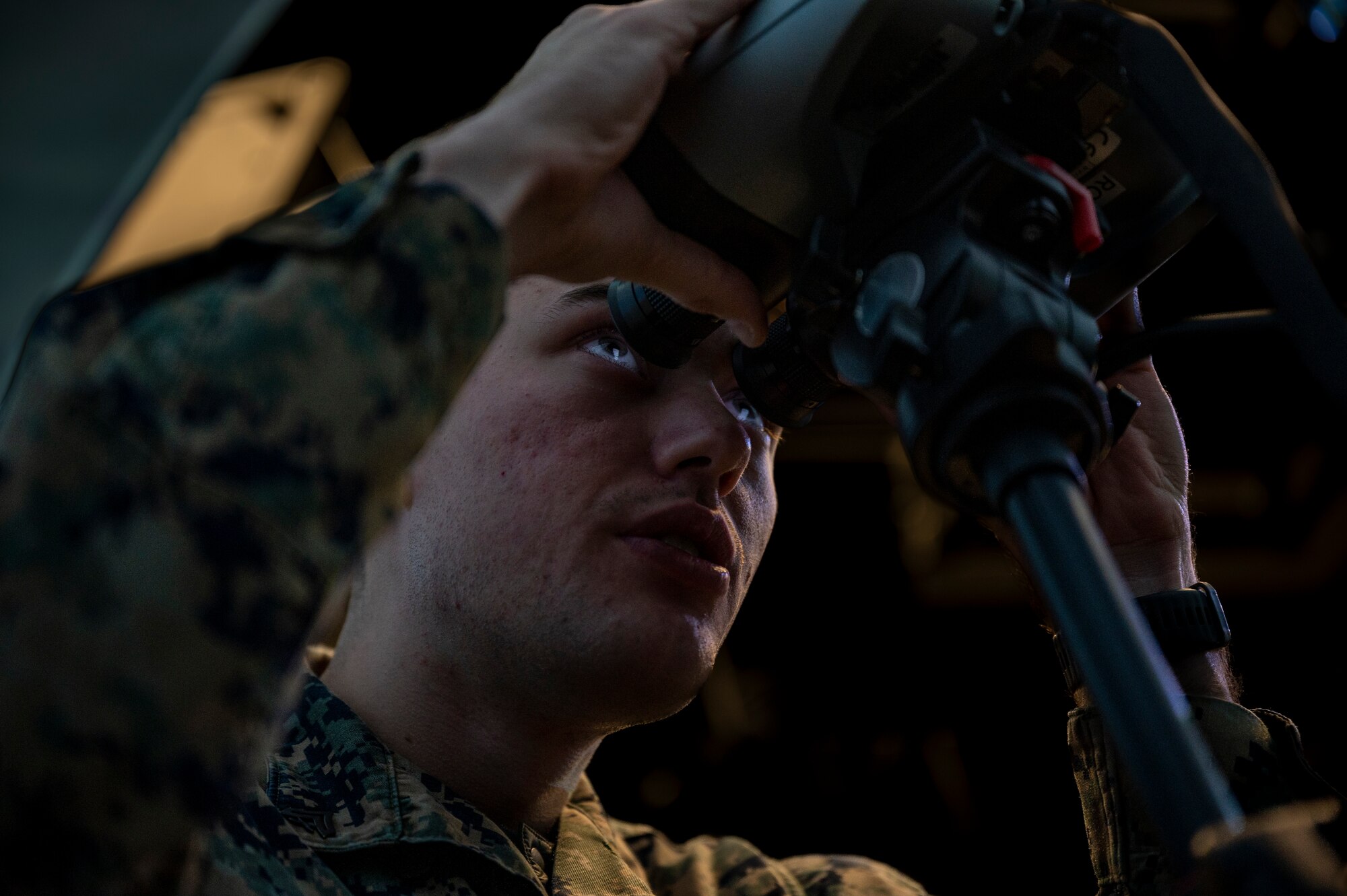 U.S. Marine Cpl. Alexandra Juncan transmission systems operator, 3rd Battalion, 4th Marine Regiment from Twentynine Palms Marine Corps Base, California, looks through a joint terminal attack controller (JTAC) simulator systems binocular during a joint training at Osan Air Base, Republic of Korea, Dec. 15, 2022.