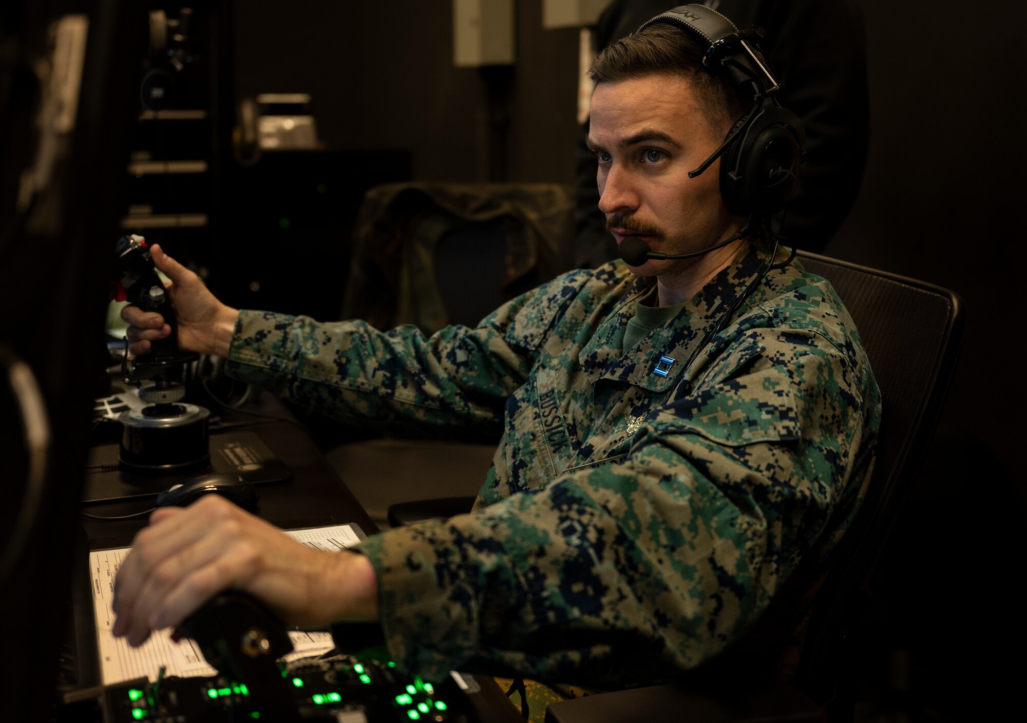 U.S. Marine Capt. William Bussick forward air controller, 3rd Battalion, 4th Marine Regiment from Twentynine Palms Marine Corps Base, California, inputs aircraft functions on a joint terminal attack controller (JTAC) simulator system at Osan Air Base, Republic of Korea, Dec. 15, 2022.