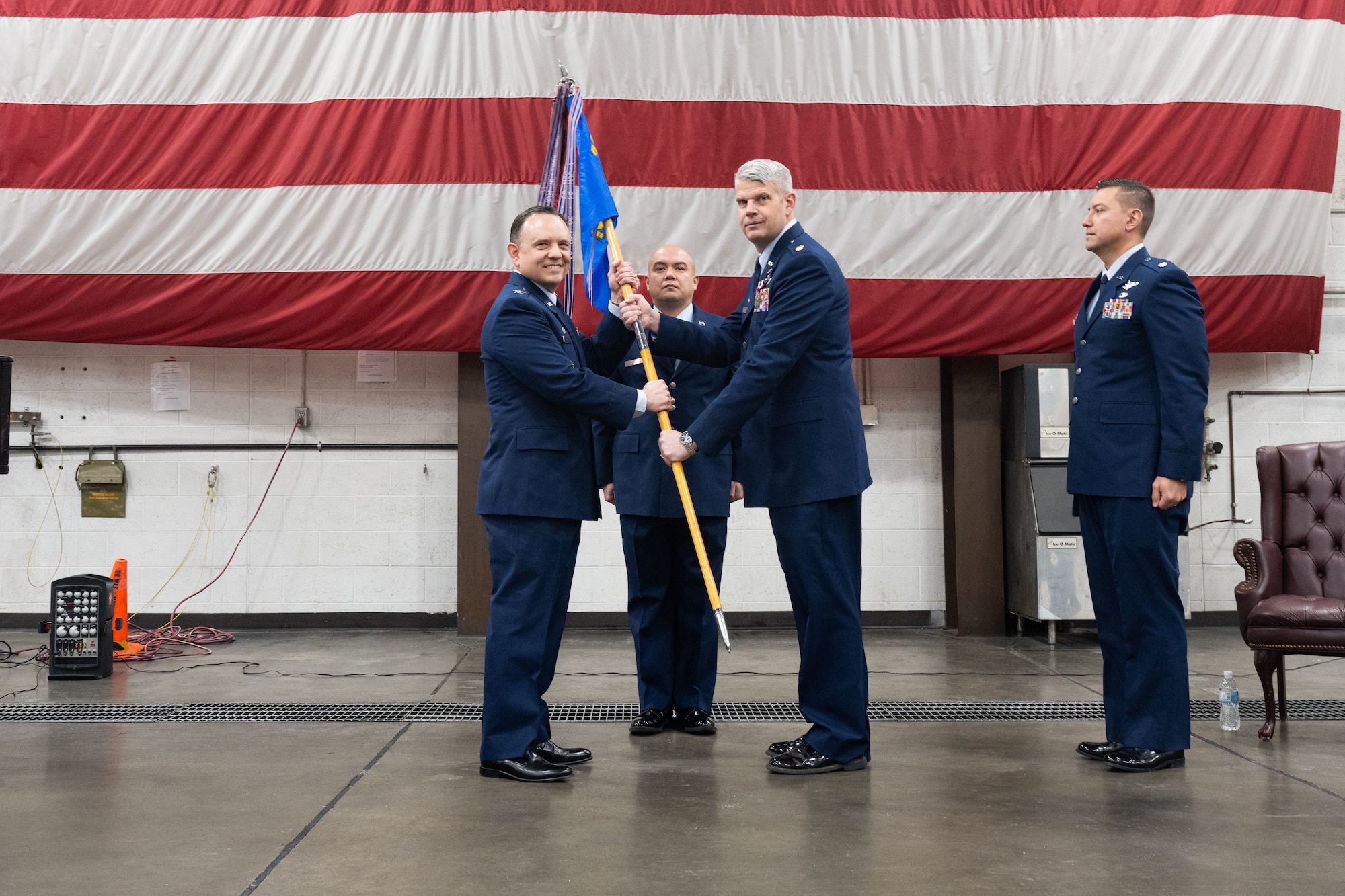 Col. Nathan Mitchell, 28th Maintenance Group commander, relinquishes Maj. Jeremy Guy, the outgoing 28th Maintenance Squadron commander, of his command over the 28th MXS at Ellsworth Air Force Base, South Dakota, Dec. 19, 2022. The change of command ceremony is an honored tradition celebrated time after time when a new commander is chosen to command a squadron or wing. (U.S. Air Force photo by Staff Sgt. Hannah Malone)