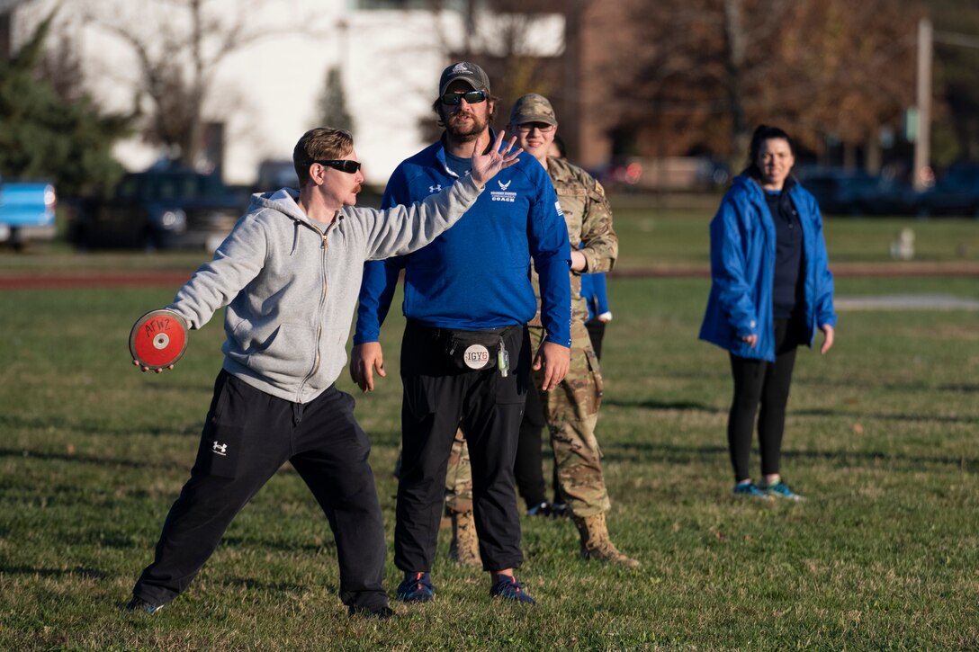 An athlete throws a discus.