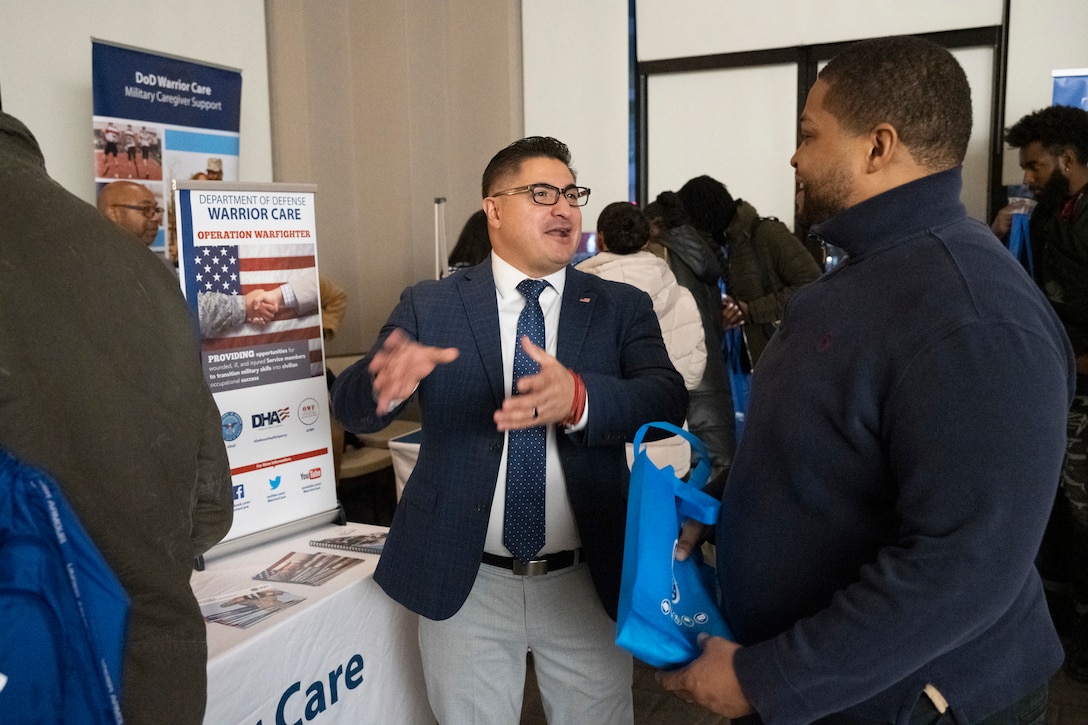 A Warrior Care representative speaks with a particpant about the OWF internship programs.