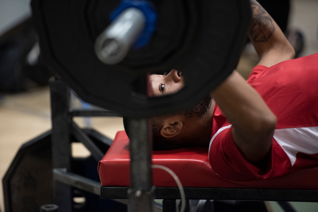 An athlete prepares to perform a bench press.