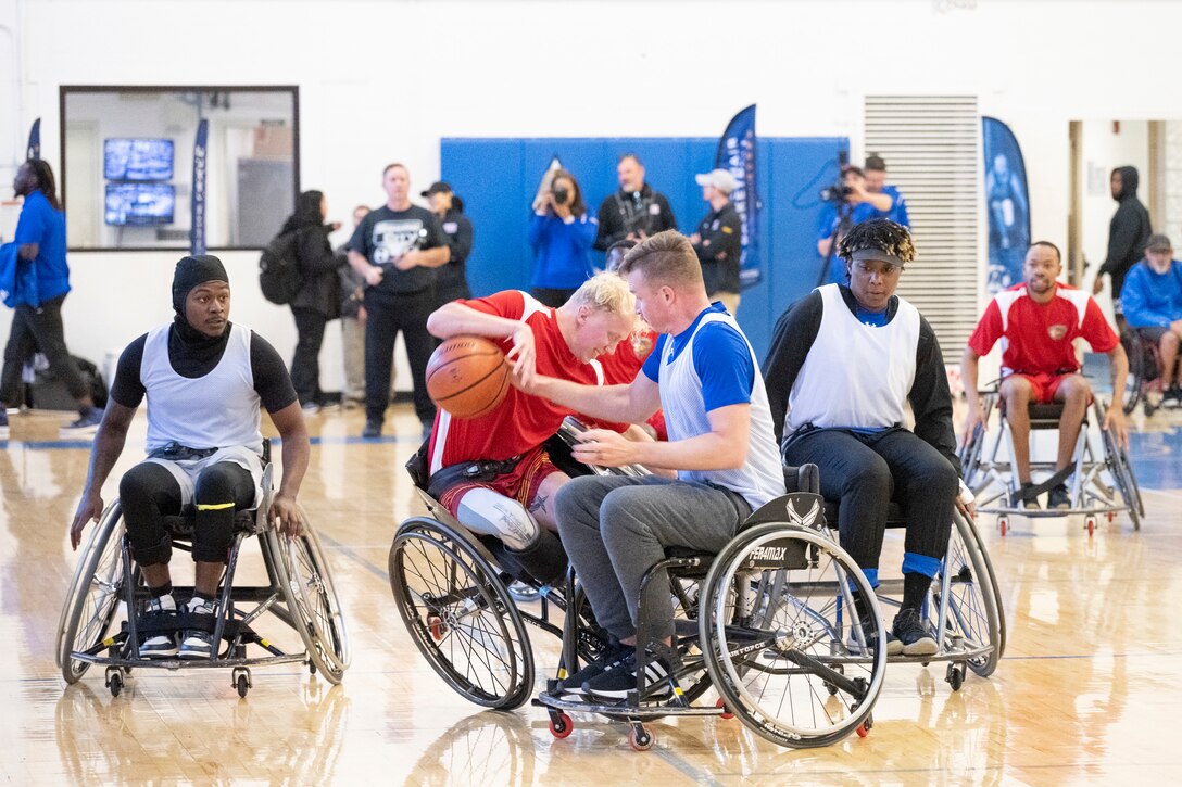 A wheelchair basketball athlete falls after colliding with an opponent.