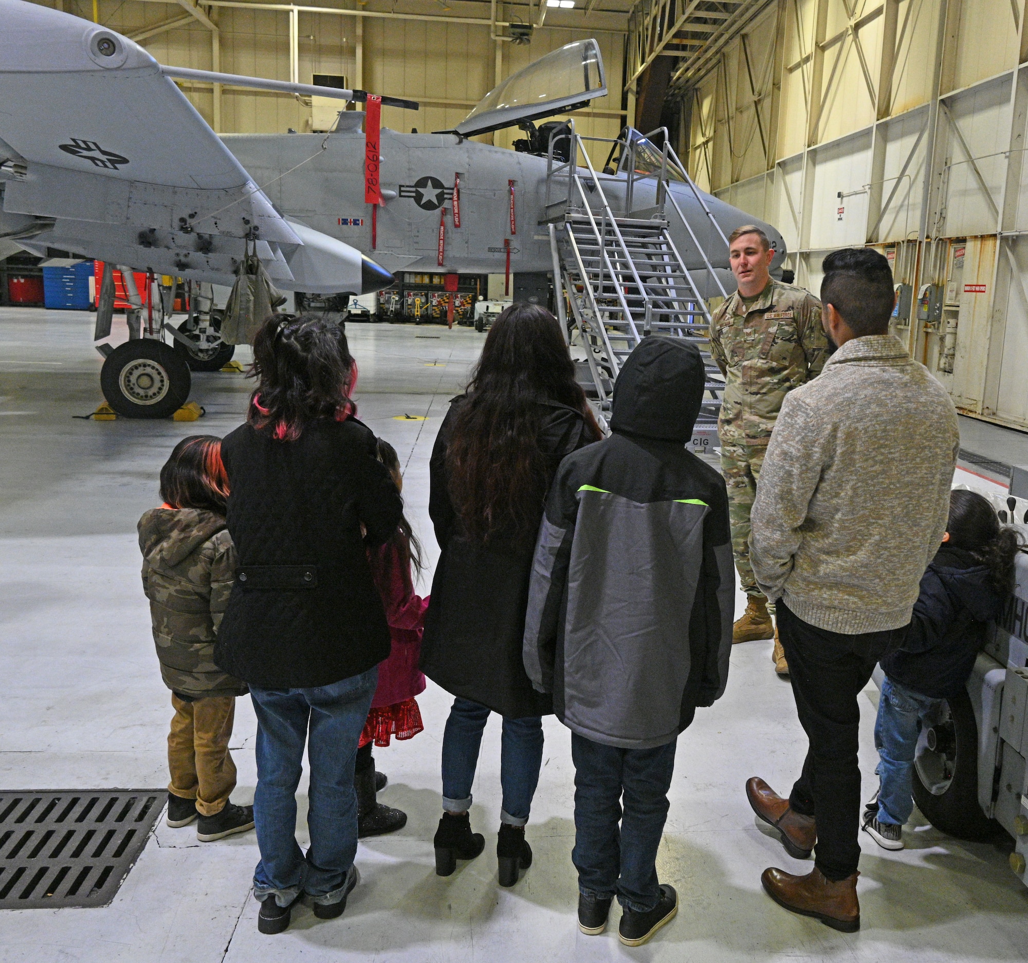 U.S. Air Force Tech. Sgt. Eric Hollman, 175th Wing recruiter, gives a tour of the A-10C Thunderbolt II aircraft to the Chavez family at Warfield Air National Guard Base at Martin State Airport, Middle River, Md., on December 20, 2022.