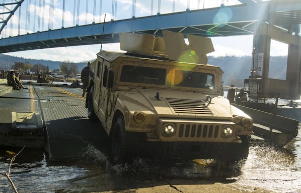 Soldiers from the 363rd Military Police Company drive their HMMWV's off an Improved Ribbon Bridge constructed by the 459th Engineer Company crossing the Ohio River traveling from West Virginia to Ohio.