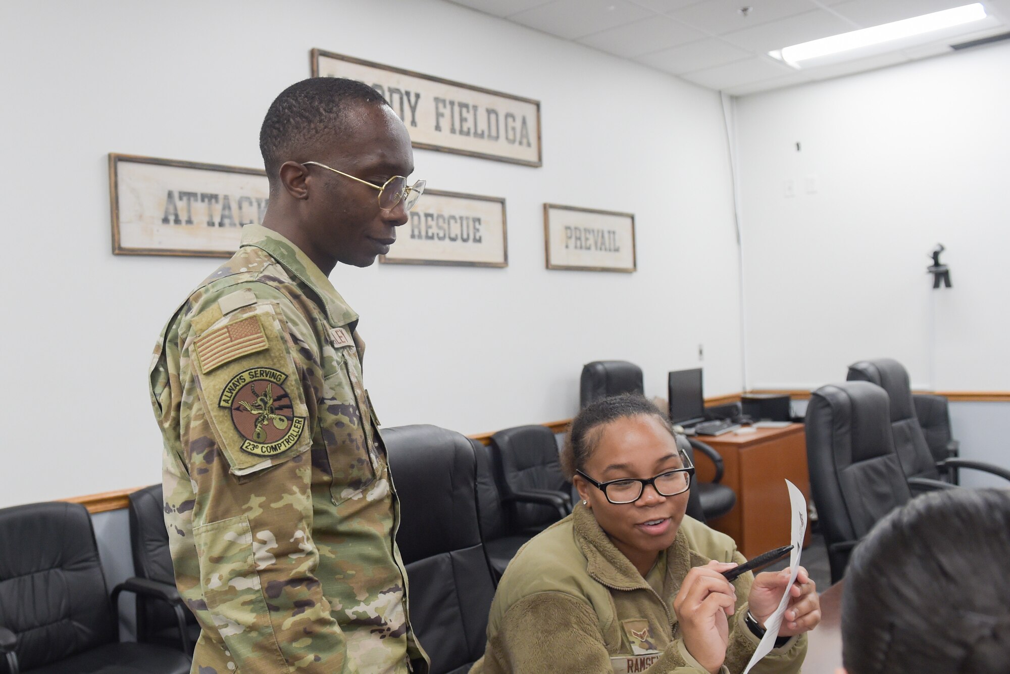 A photo of Airmen talking.