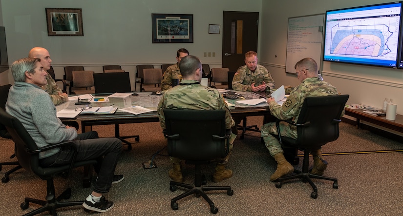 Members of the Pennsylvania National Guard Joint Operations Center staff participate in a conference call, from the Joint Operations Center conference room, with members across the commonwealth as part of a winter storm tabletop exercise designed to improve and validate domestic response procedures Dec 20, 2022 at Fort Indiantown Gap, Pa. (Pennsylvania National Guard photo by Wayne V. Hall)