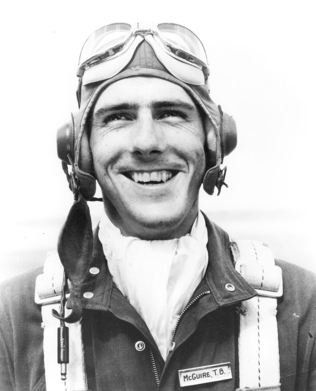 A man in aviator gear smiles.