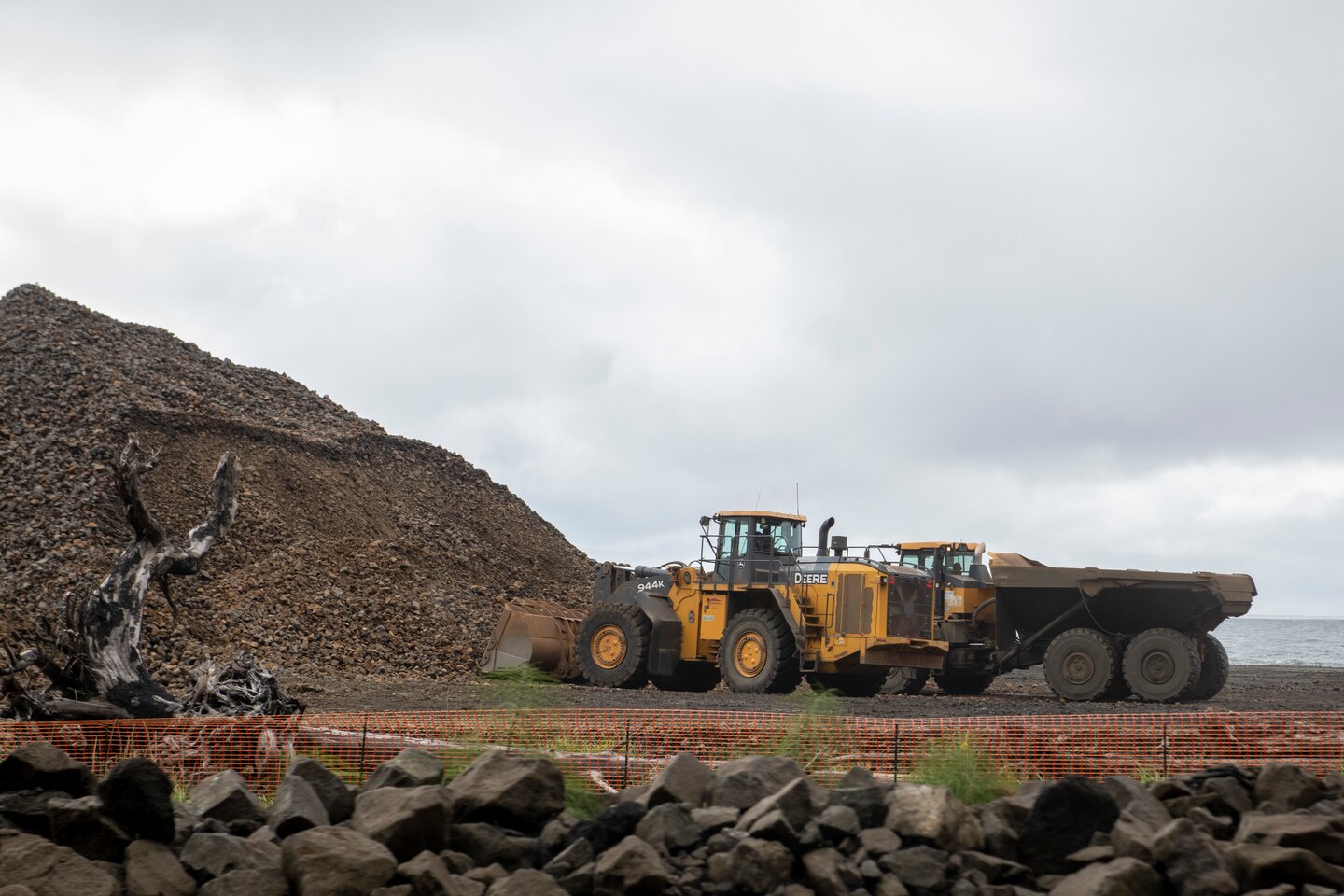 Photo of construction truck and dump truck waiting to load road and transport materials.