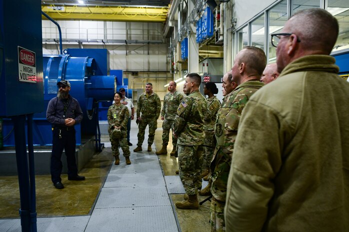 The members of the California Installation Commanders Caucus (CICC) stand in the radar of the 7th Space Warning Squadron on Beale Air Force Base, Calif. on Dec. 7, 2022.