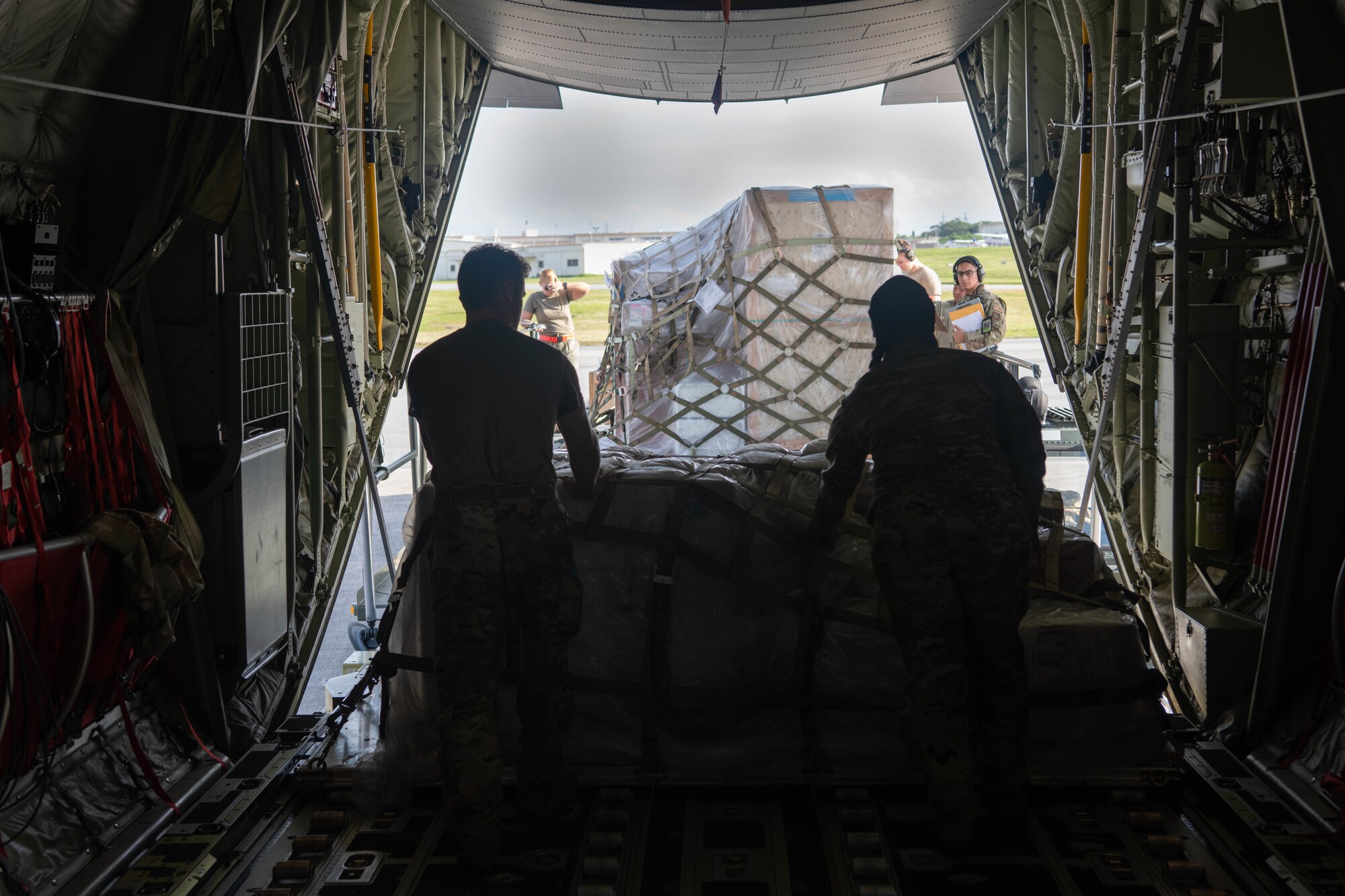 Airmen unload cargo.