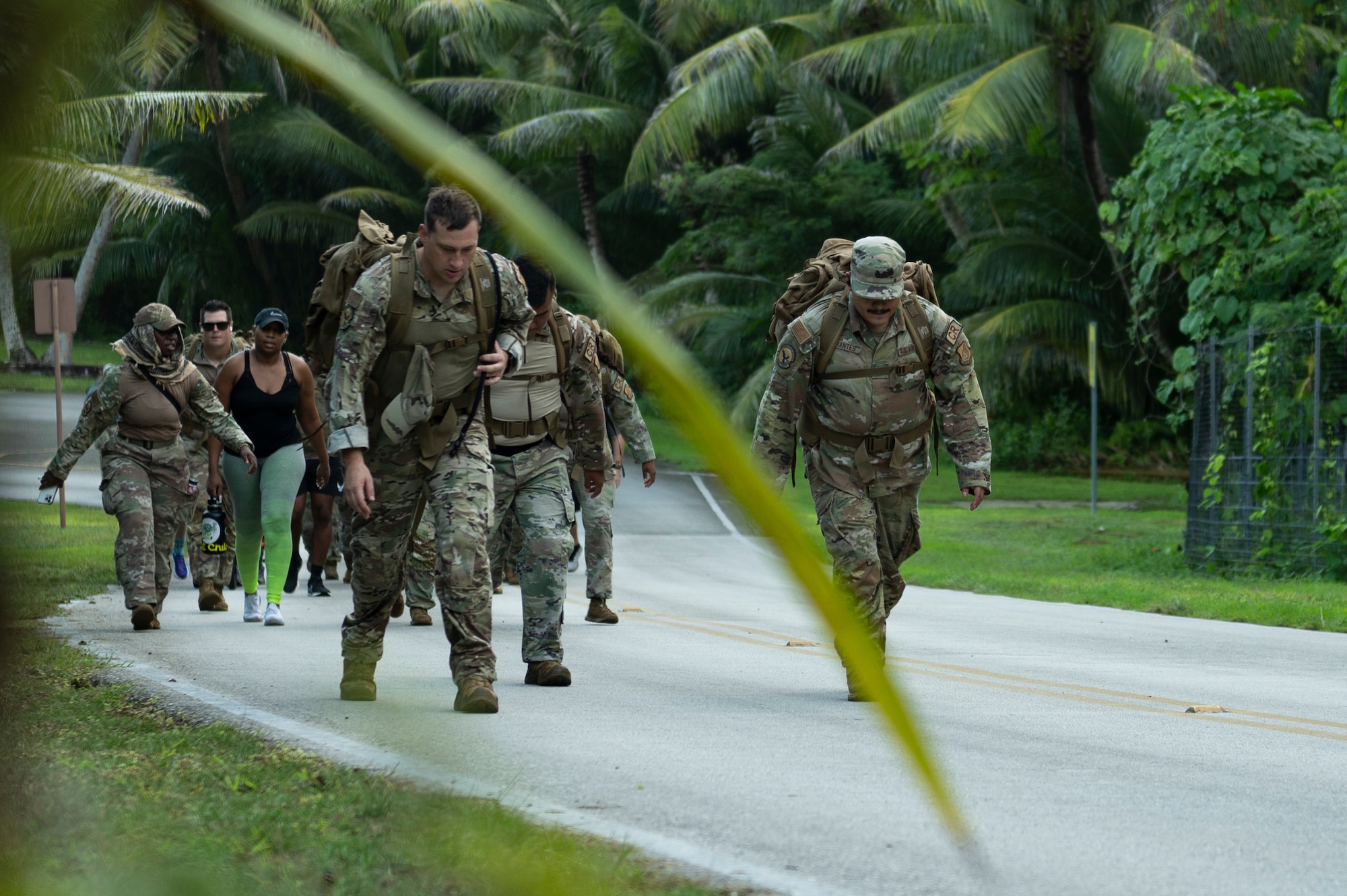 U.S. Air Force service members and their families walk from Tarague beach to Sanders Slope during the Office of Special Investigations’ Hustler-6 memorial event on Andersen Air Force Base, Guam, Dec. 21, 2022. Since 2016, OSI agents assigned to Andersen AFB have annually honored the Hustler-6, who lost their lives during a mission near Bagram, Afghanistan on Dec. 21, 2015, by rucking up and down Sanders Slope. (U.S. Air Force photo by Airman Spencer Perkins)