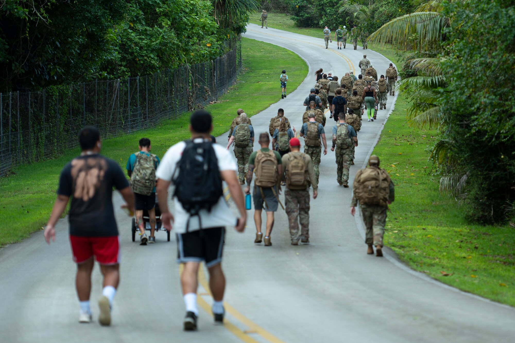 U.S. Air Force service members and their families walk from Tarague beach to Sanders Slope during the Office of Special Investigations’ Hustler-6 memorial event on Andersen Air Force Base, Guam, Dec. 21, 2022. Since 2016, OSI agents assigned to Andersen AFB have annually honored the Hustler-6, who lost their lives during a mission near Bagram, Afghanistan on Dec. 21, 2015, by rucking up and down Sanders Slope. (U.S. Air Force photo by Airman Spencer Perkins)