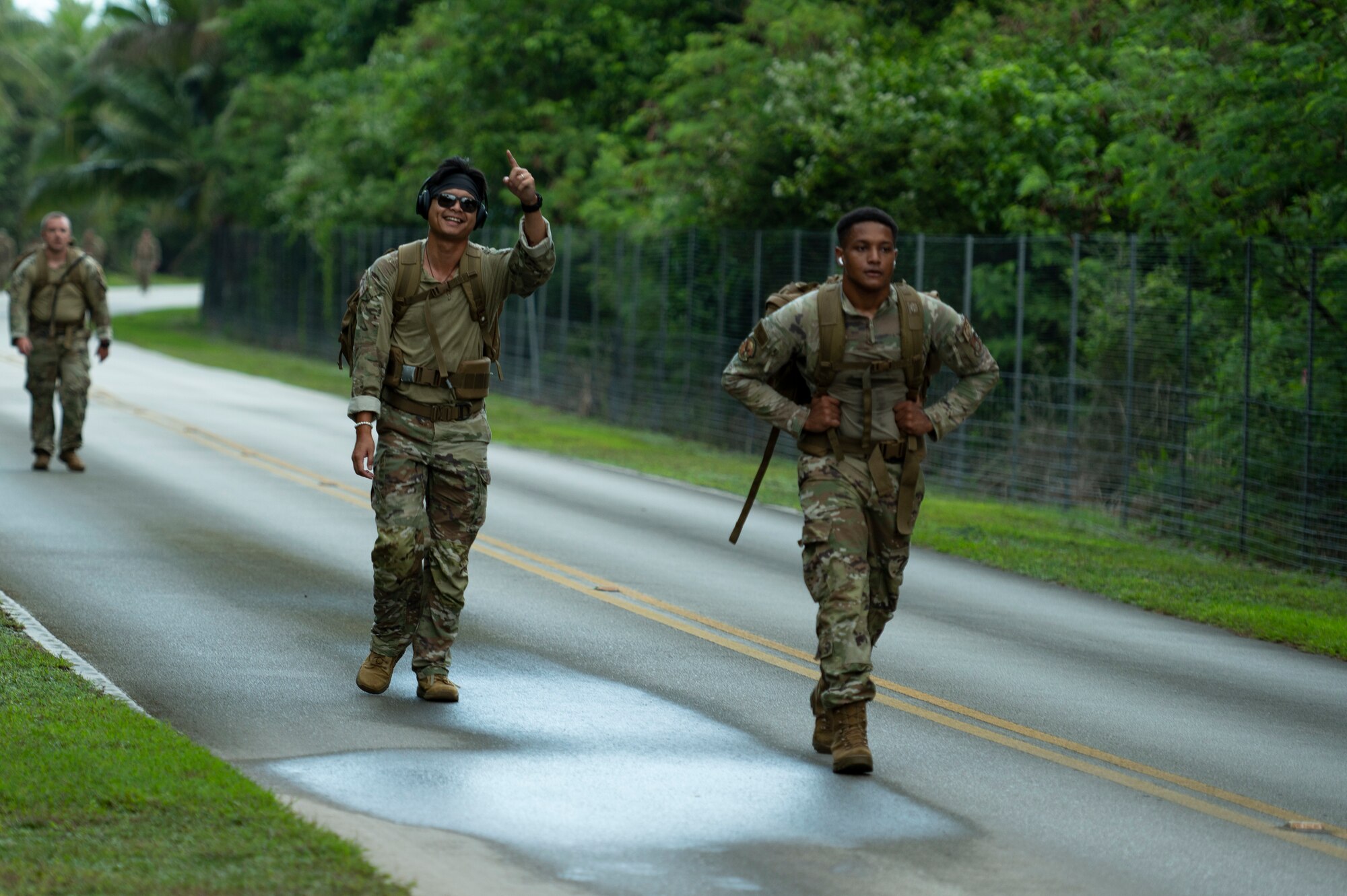 U.S. Air Force service members walk from Tarague beach to Sanders Slope during the Office of Special Investigations’ Hustler-6 memorial event on Andersen Air Force Base, Guam, Dec. 21, 2022. Since 2016, OSI agents assigned to Andersen AFB have annually honored the Hustler-6, who lost their lives during a mission near Bagram, Afghanistan on Dec. 21, 2015, by rucking up and down Sanders Slope. (U.S. Air Force photo by Airman Spencer Perkins)