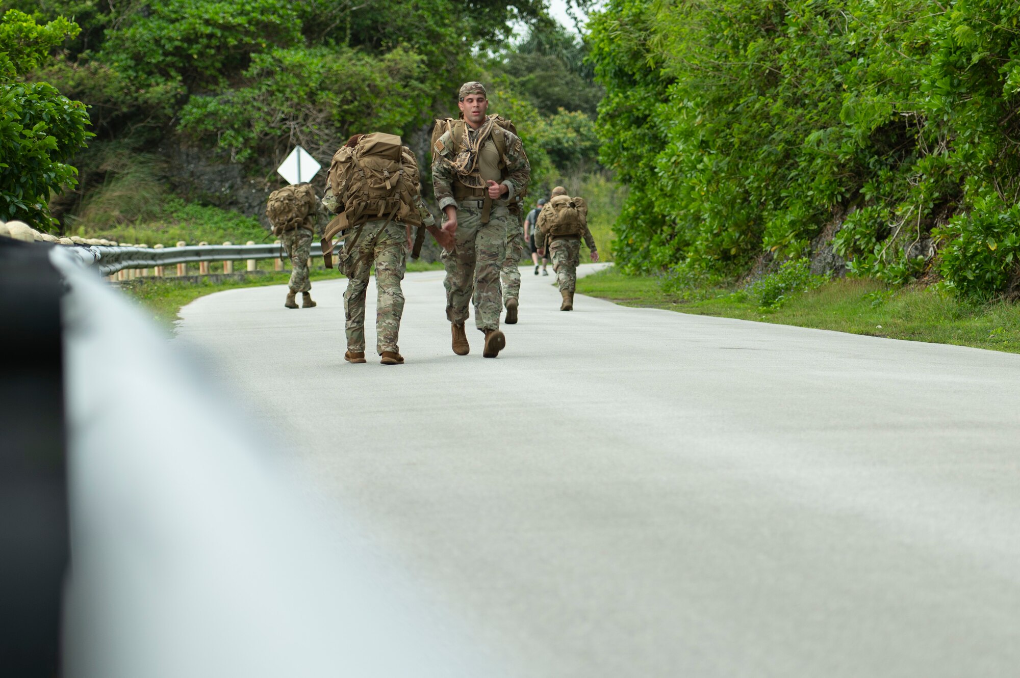 U.S. Air Force service members walk from Tarague beach to Sanders Slope during the Office of Special Investigations’ Hustler-6 memorial event on Andersen Air Force Base, Guam, Dec. 21, 2022. Since 2016, OSI agents assigned to Andersen AFB have annually honored the Hustler-6, who lost their lives during a mission near Bagram, Afghanistan on Dec. 21, 2015, by rucking up and down Sanders Slope. (U.S. Air Force photo by Airman Spencer Perkins)