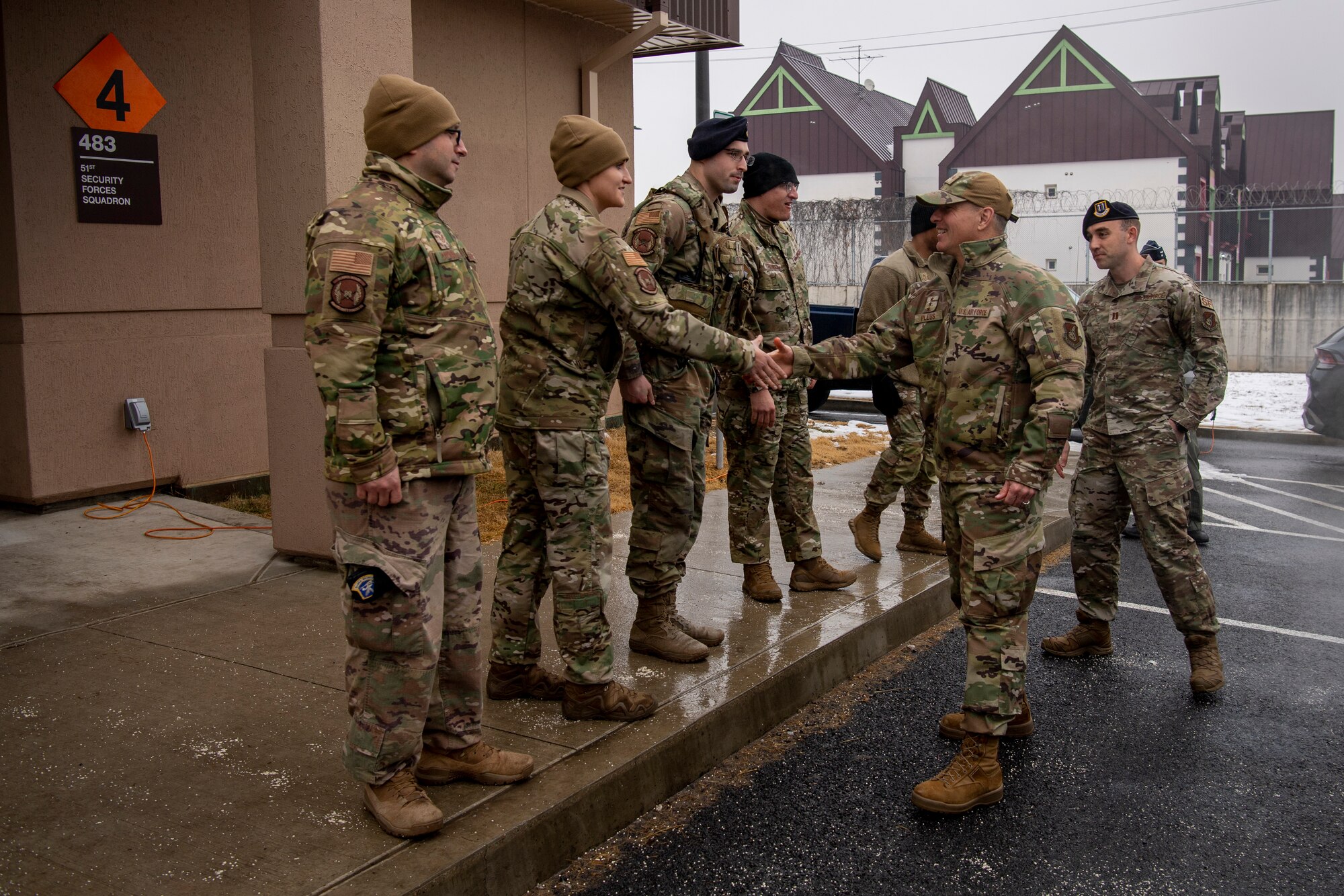 U.S. Air Force Lt. Gen. Scott Pleus (right), 7th Air Force commander, is greeted by 51st Security Forces Squadron (SFS) members at the 51st SFS military working dog (MWD) facility, Dec. 21, 2022, at Osan Air Base, Republic of Korea.