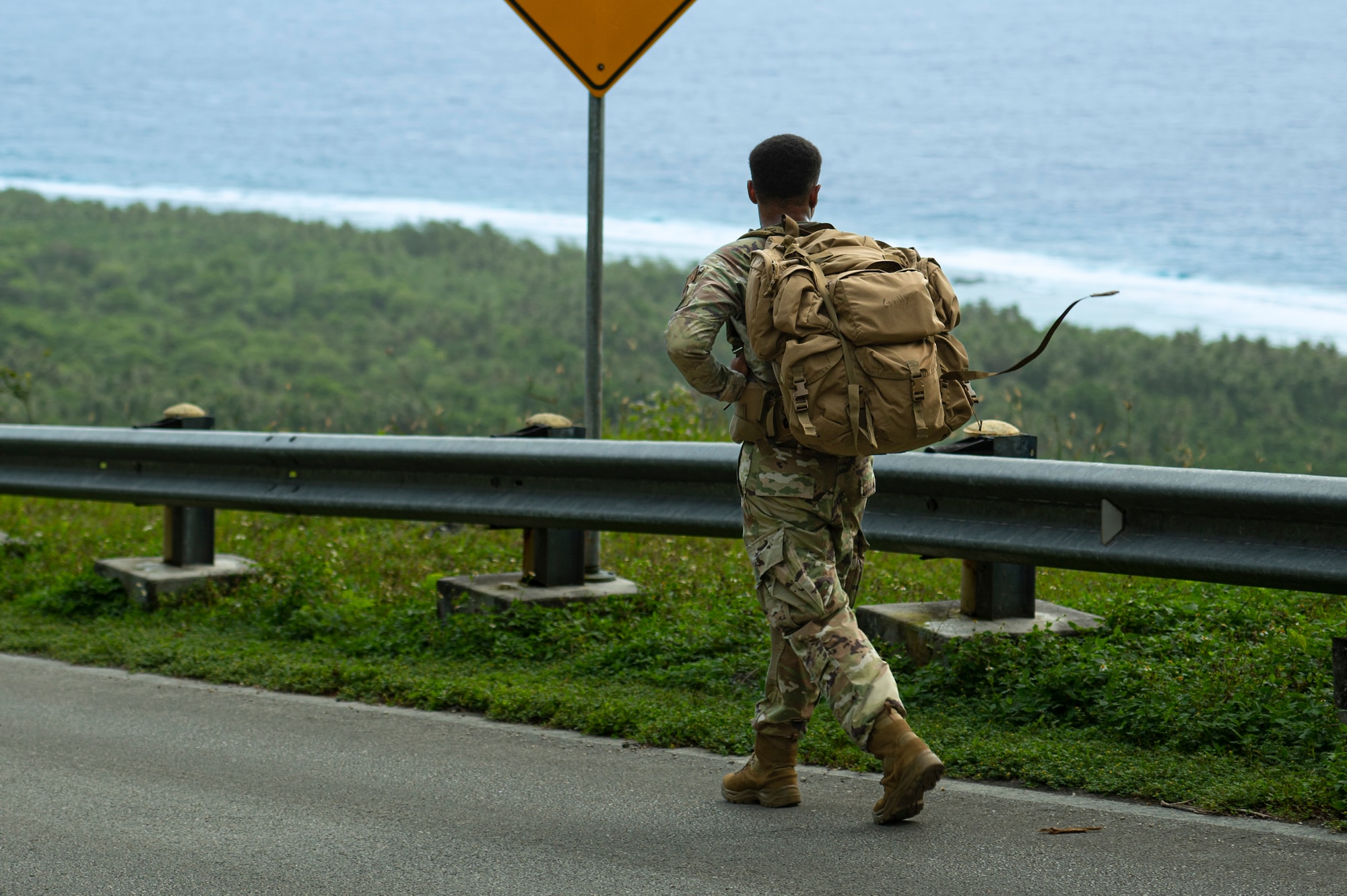 A U.S. Air Force service member walks down Sanders Slope during the Office of Special Investigations’ Hustler-6 memorial event on Andersen Air Force Base, Guam, Dec. 21, 2022. Since 2016, OSI agents assigned to Andersen AFB have annually honored the Hustler-6, who lost their lives during a mission near Bagram, Afghanistan on Dec. 21, 2015, by rucking up and down Sanders Slope. (U.S. Air Force photo by Airman Spencer Perkins)