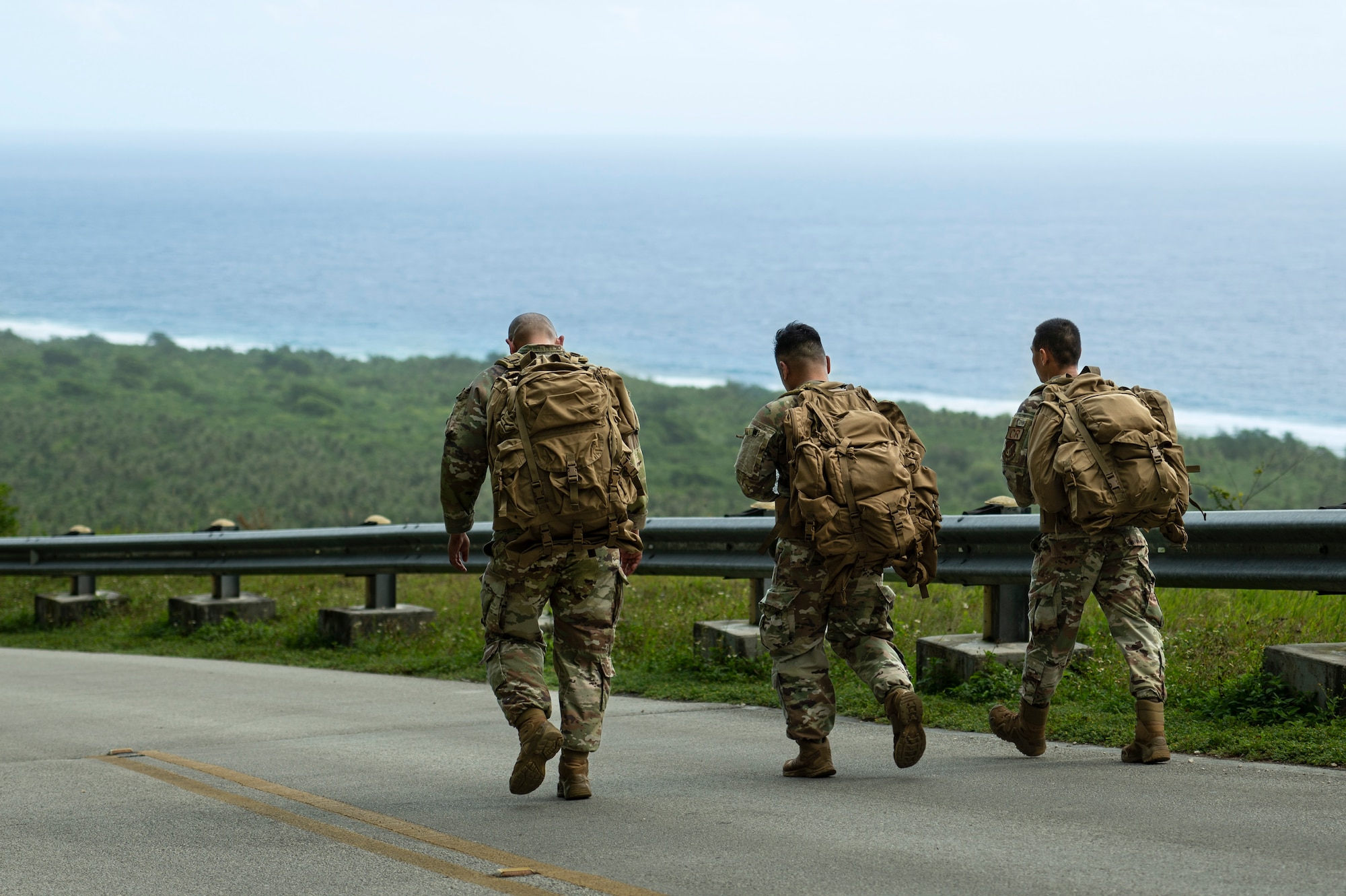 U.S. Air Force service members walk down Sanders Slope during the Office of Special Investigations’ Hustler-6 memorial on Andersen Air Force Base, Guam, Dec. 21, 2022. Since 2016, OSI agents assigned to Andersen AFB have annually honored the Hustler-6, who lost their lives during a mission near Bagram, Afghanistan on Dec. 21, 2015, by rucking up and down Sanders Slope. (U.S. Air Force photo by Airman Spencer Perkins)