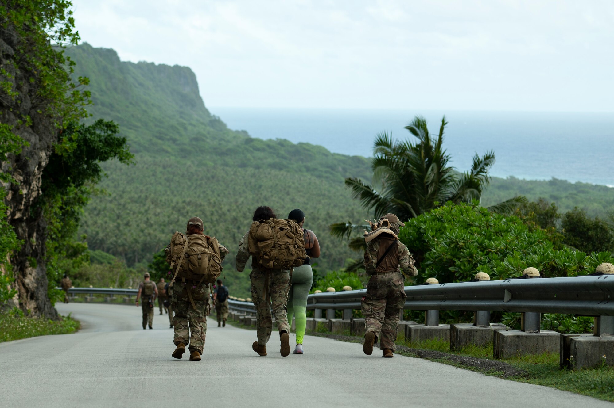 U.S. Air Force service members walk down Sanders Slope during the Office of Special Investigations’ Hustler-6 memorial on Andersen Air Force Base, Guam, Dec. 21, 2022. Since 2016, OSI agents assigned to Andersen AFB have annually honored the Hustler-6, who lost their lives during a mission near Bagram, Afghanistan on Dec. 21, 2015, by rucking up and down Sanders Slope. (U.S. Air Force photo by Airman Spencer Perkins)